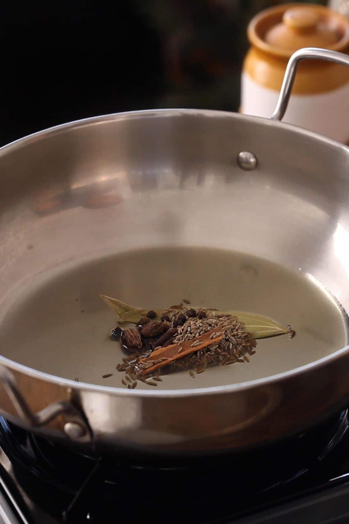 Hot oil is tempered with whole spices.