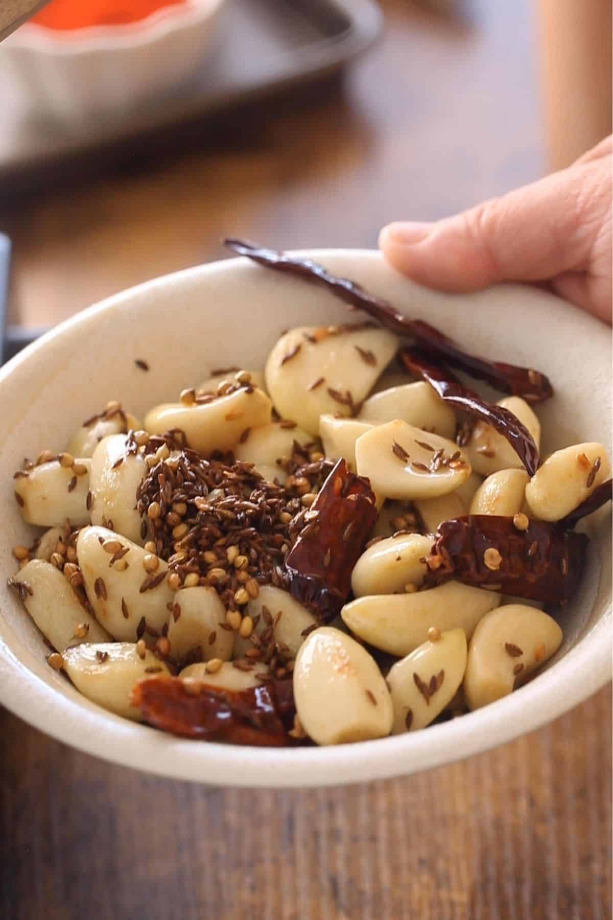 Cooling down the garlic and spices.