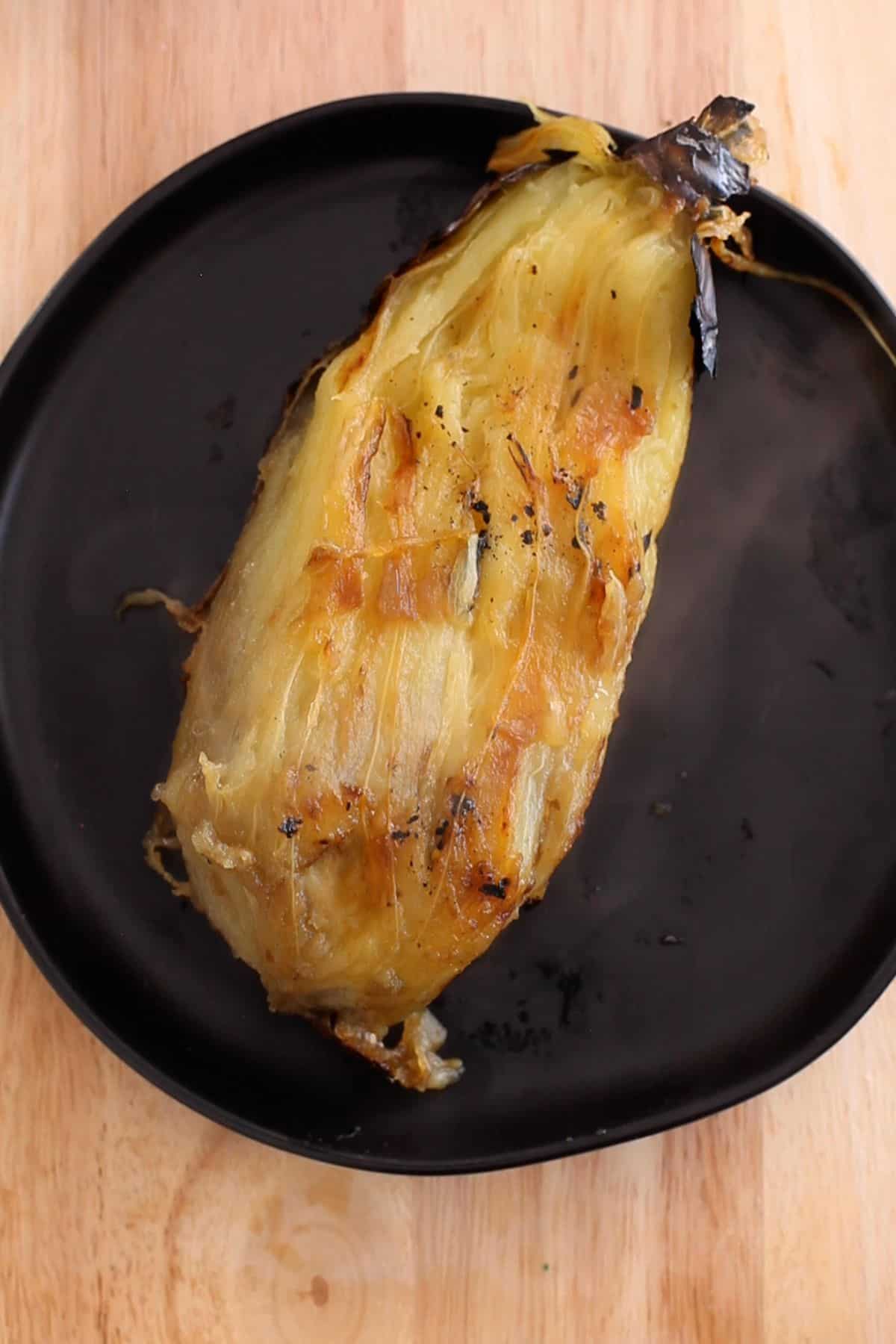 Charred skin of eggplant is peeled.