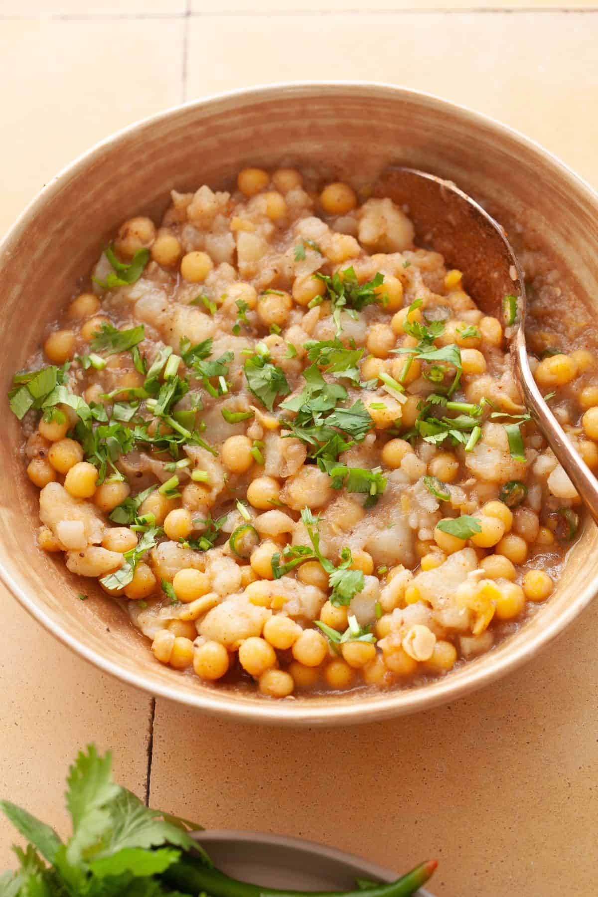 Golgappa potatoes stuffling garnished with cilantro.
