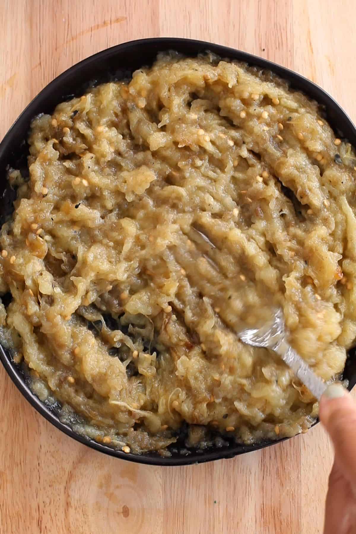 Roasted Eggplant mashed with fork.