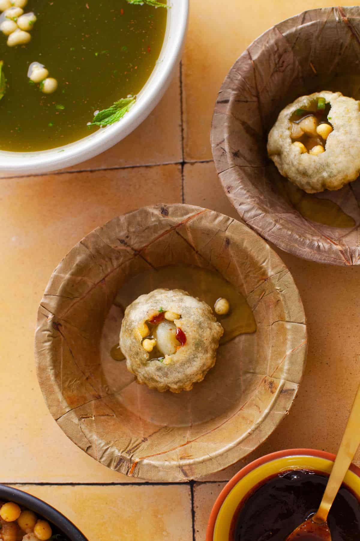 Panipuri served in palm leaf bowls.