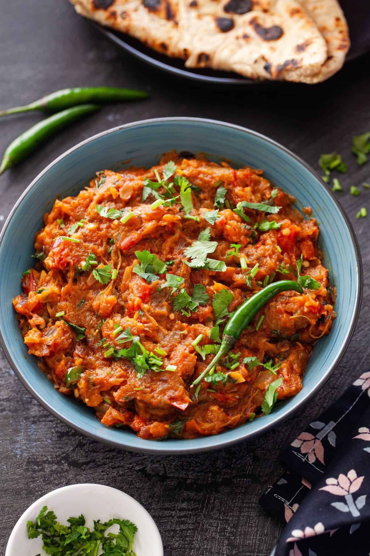 Eggplant bharta served in a blue bowl.