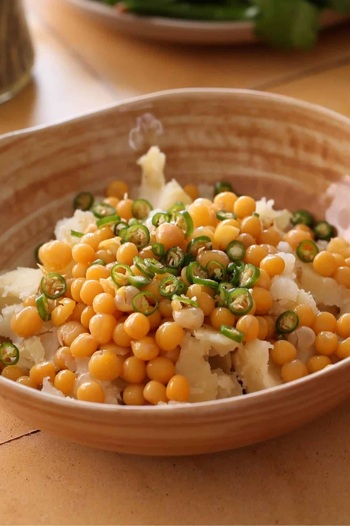 Boiled potatoes and white peas in a large bowl.