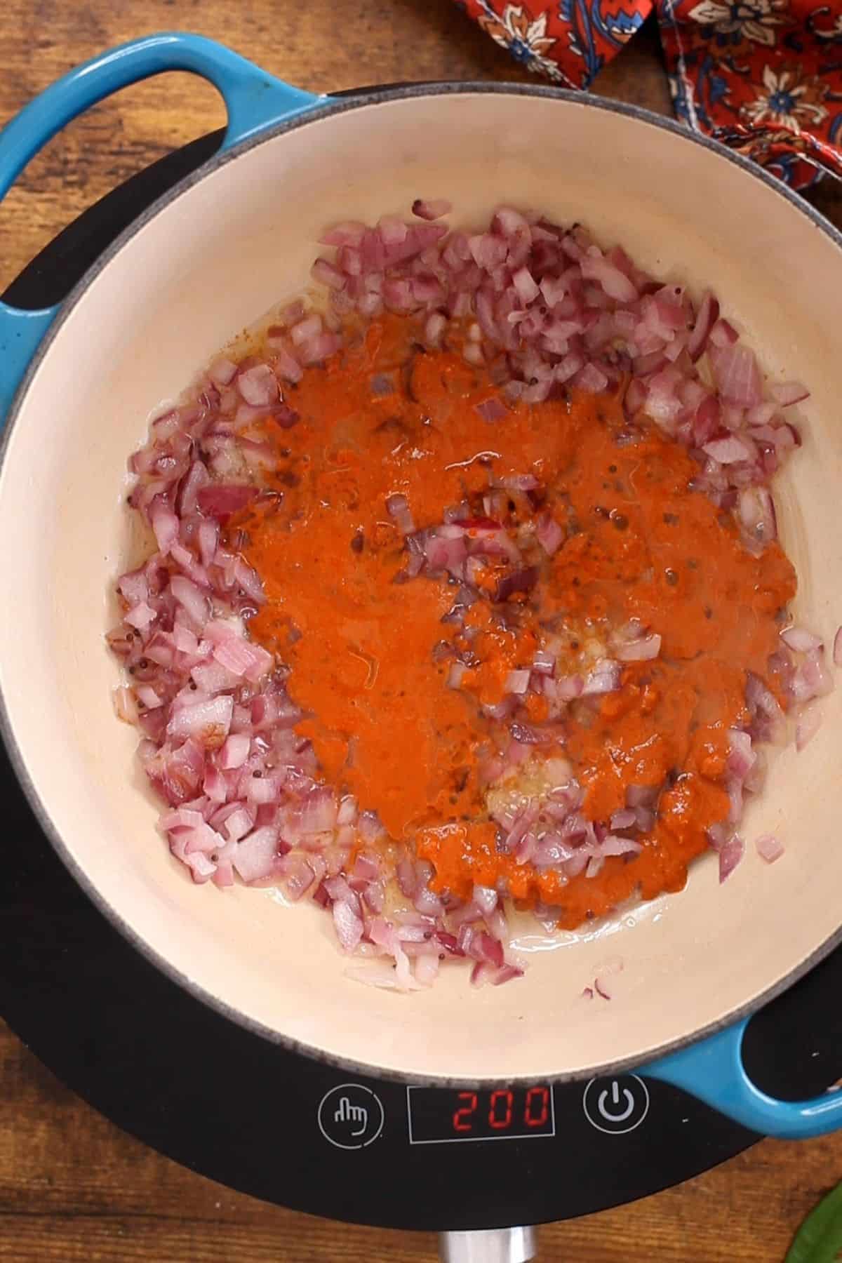 Vindaloo paste is added to the browned onions.