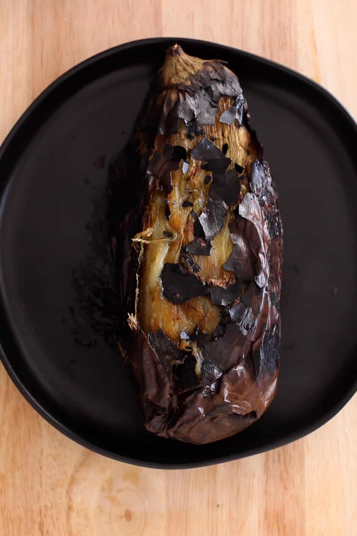 Roasted eggplant placed on a grey plate.