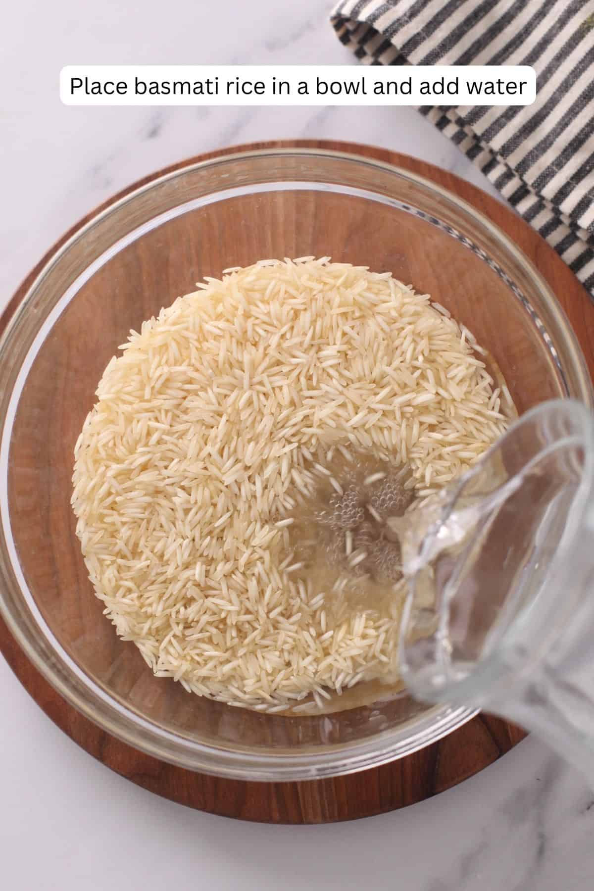 Pouring water over raw basmati rice.