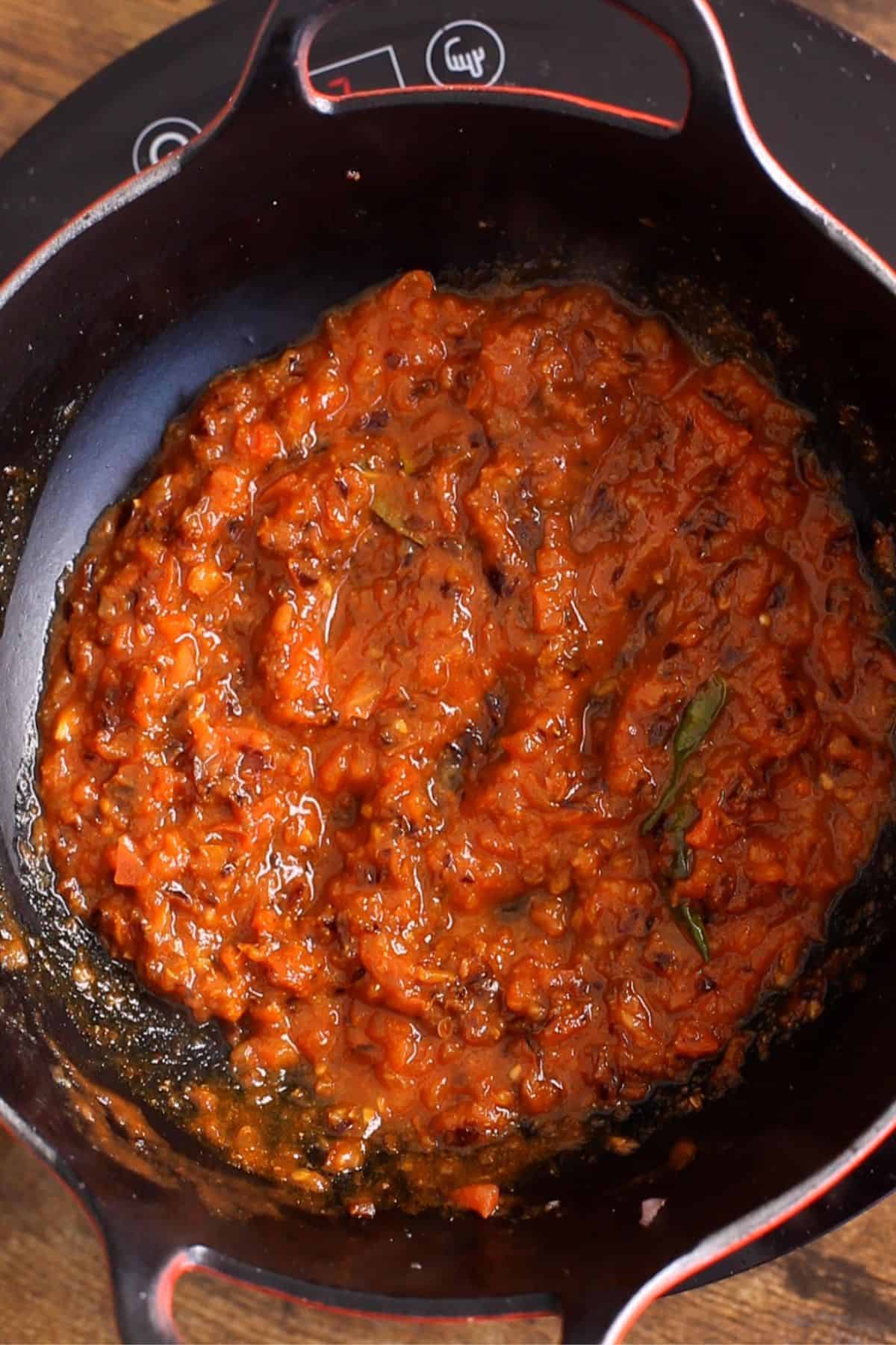 Tomatoes are cooked until oil seperates.