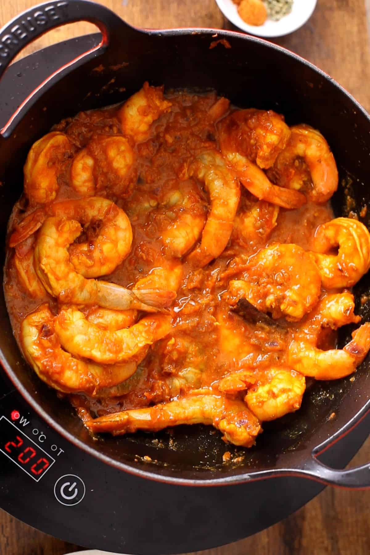Shrimp is cooked on low heat until orange and opaque.
