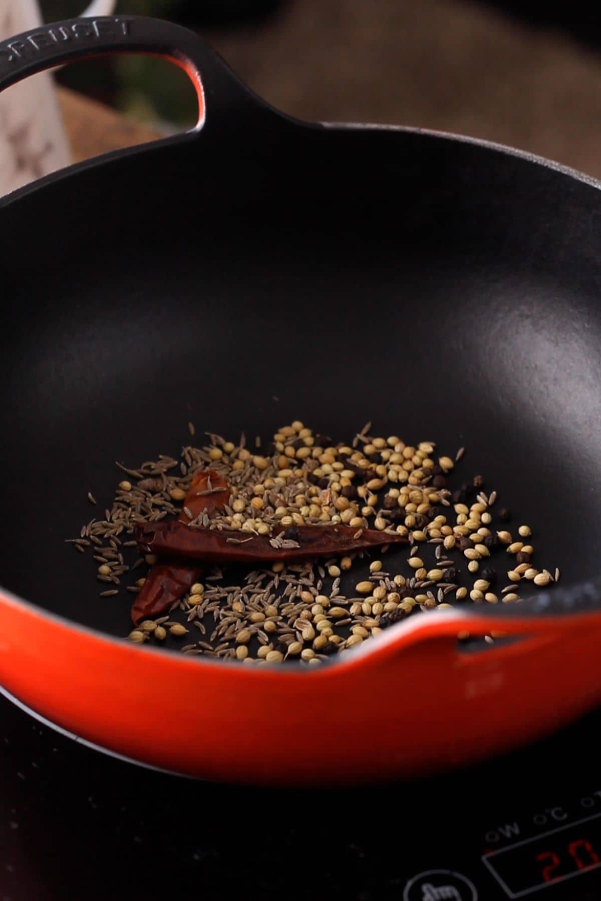 Dry roasting whole spices to make kadai spice blend.