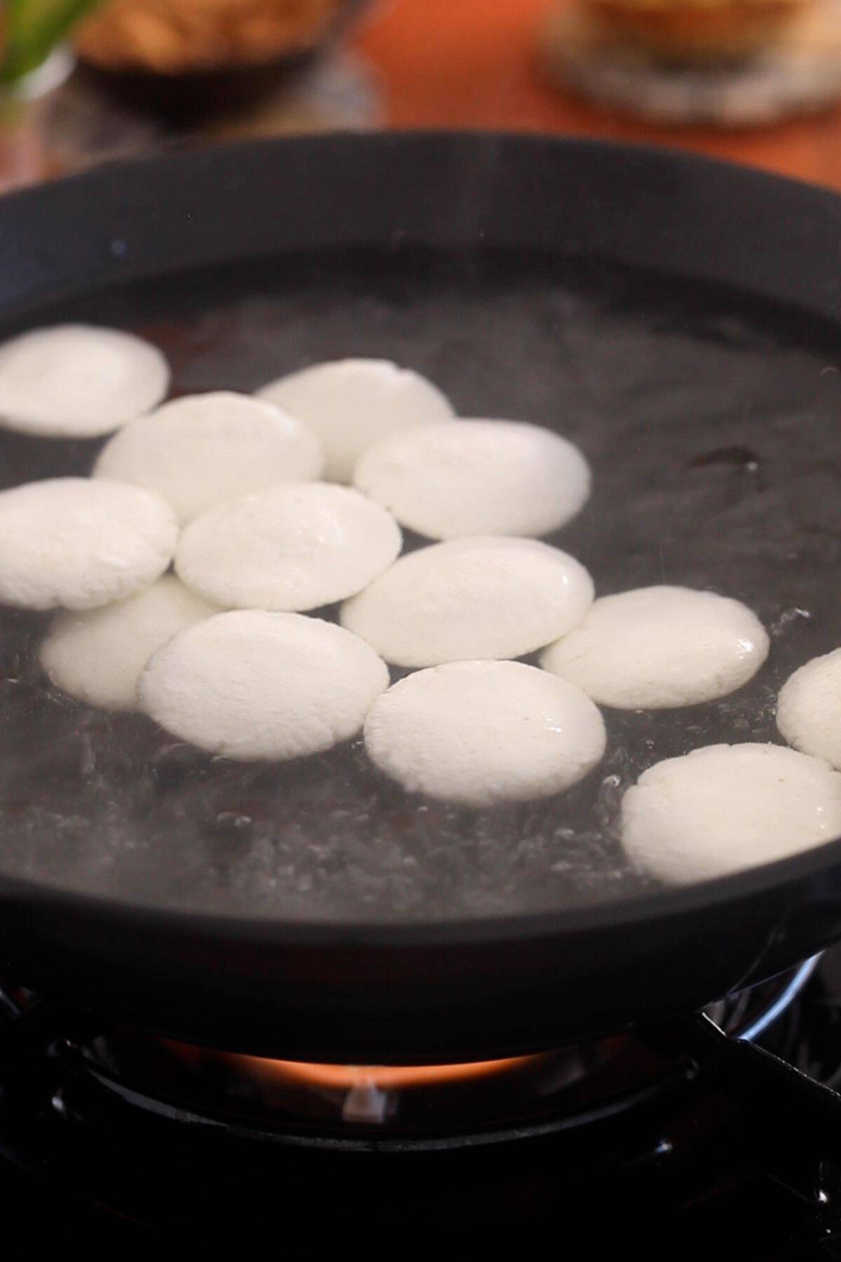 Rasmalai patties are added to boiling sugar syrup.