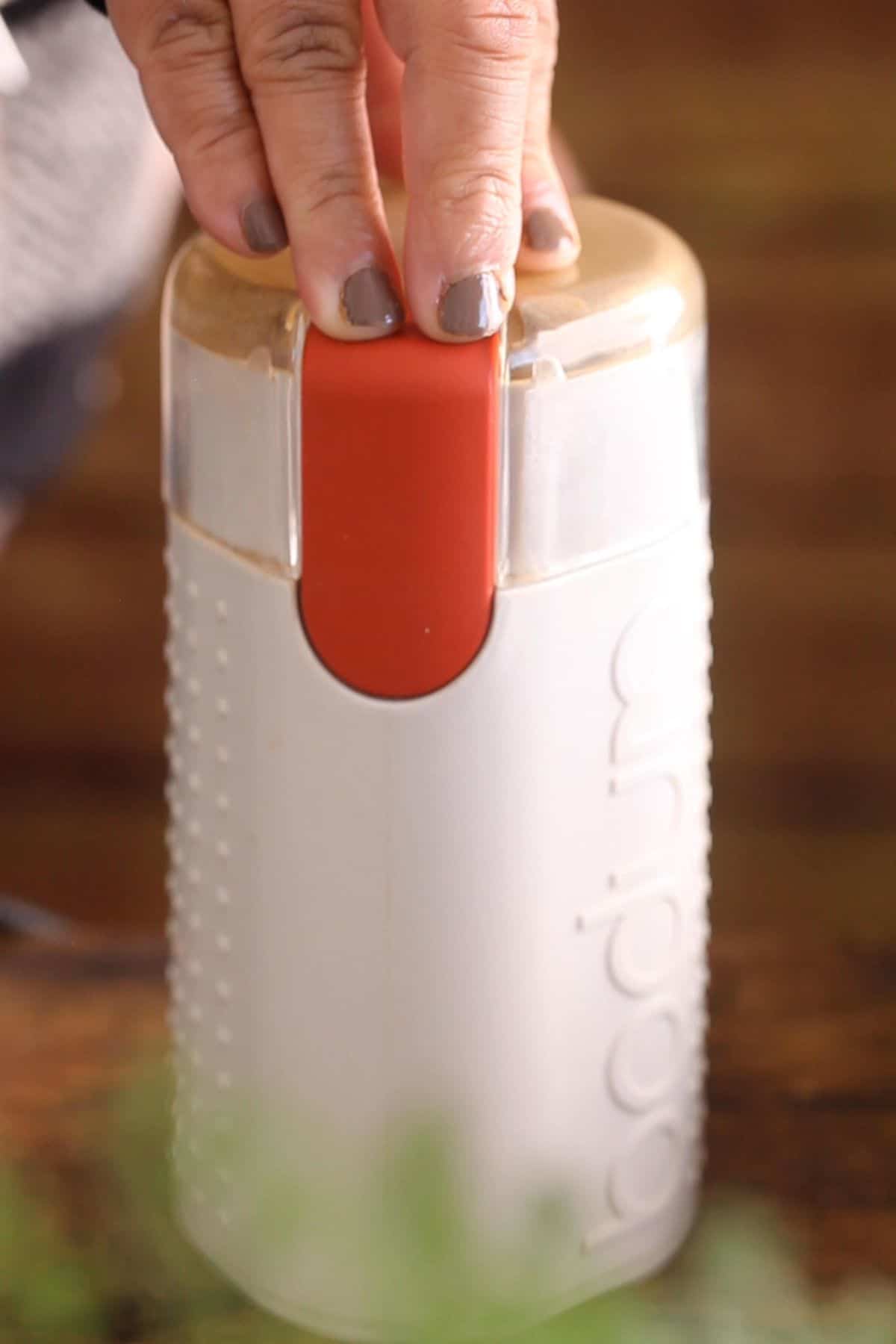 Grinding kadai masala in a coffee grinder.