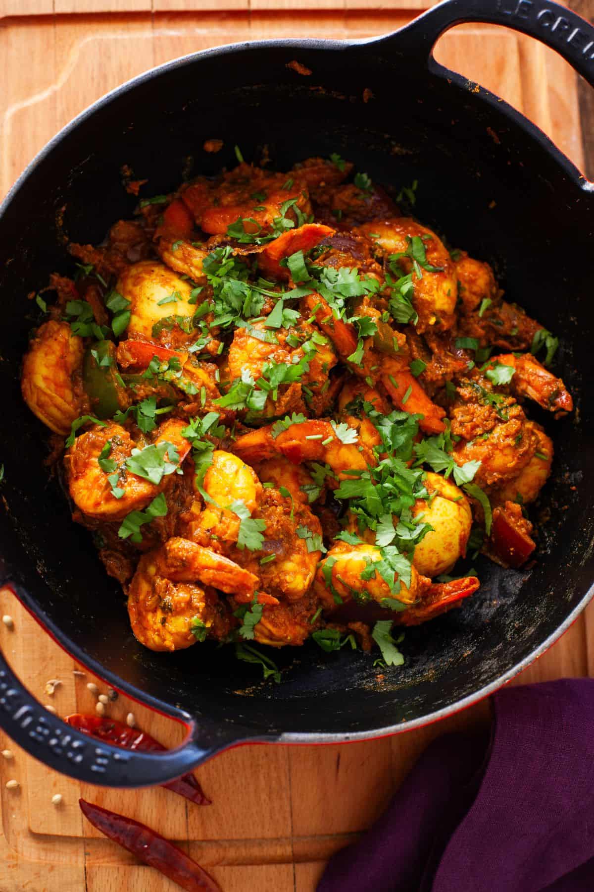 Kadai shrimp cooked in a cast iron wok. 