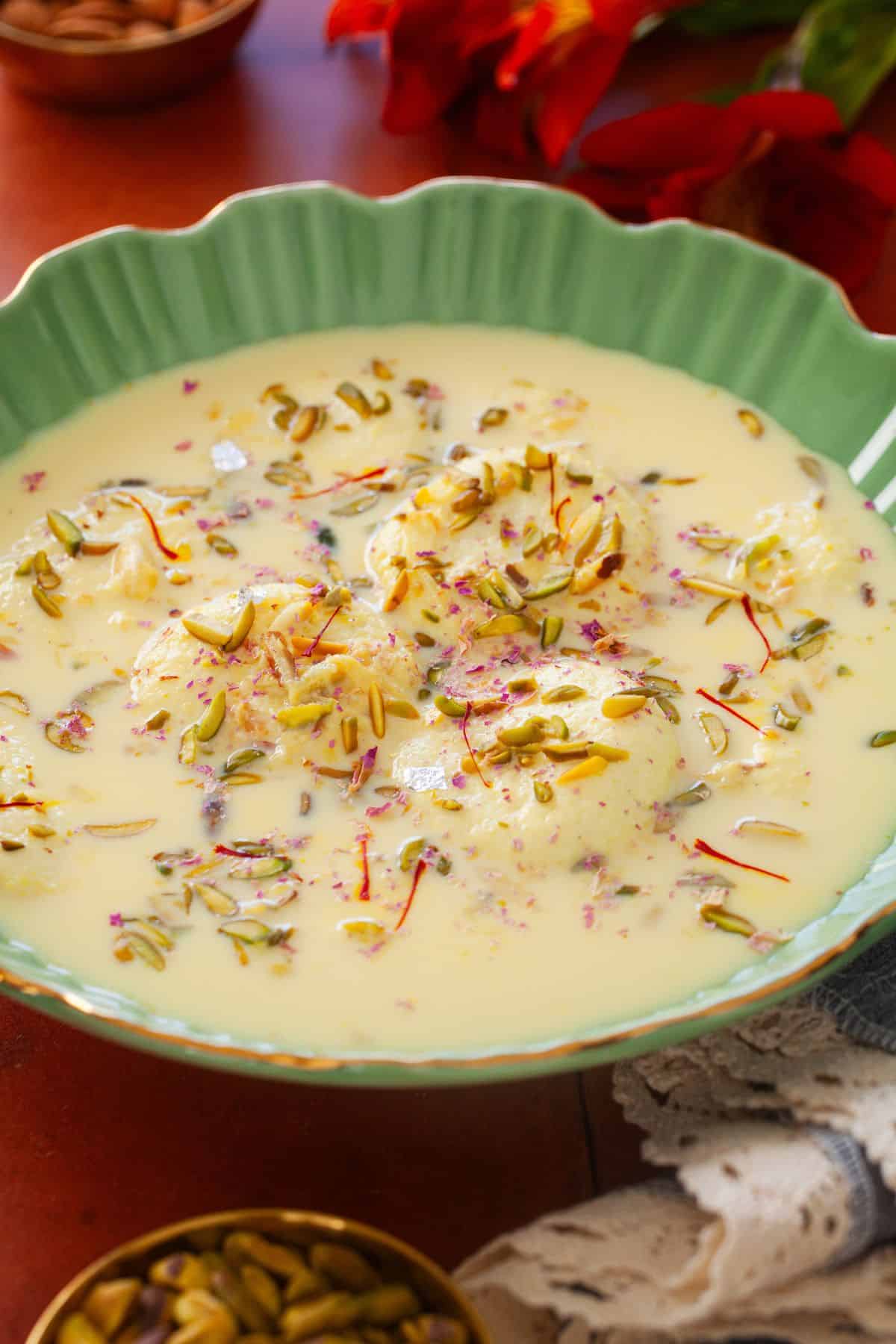 Rasmalai garnished with nuts.