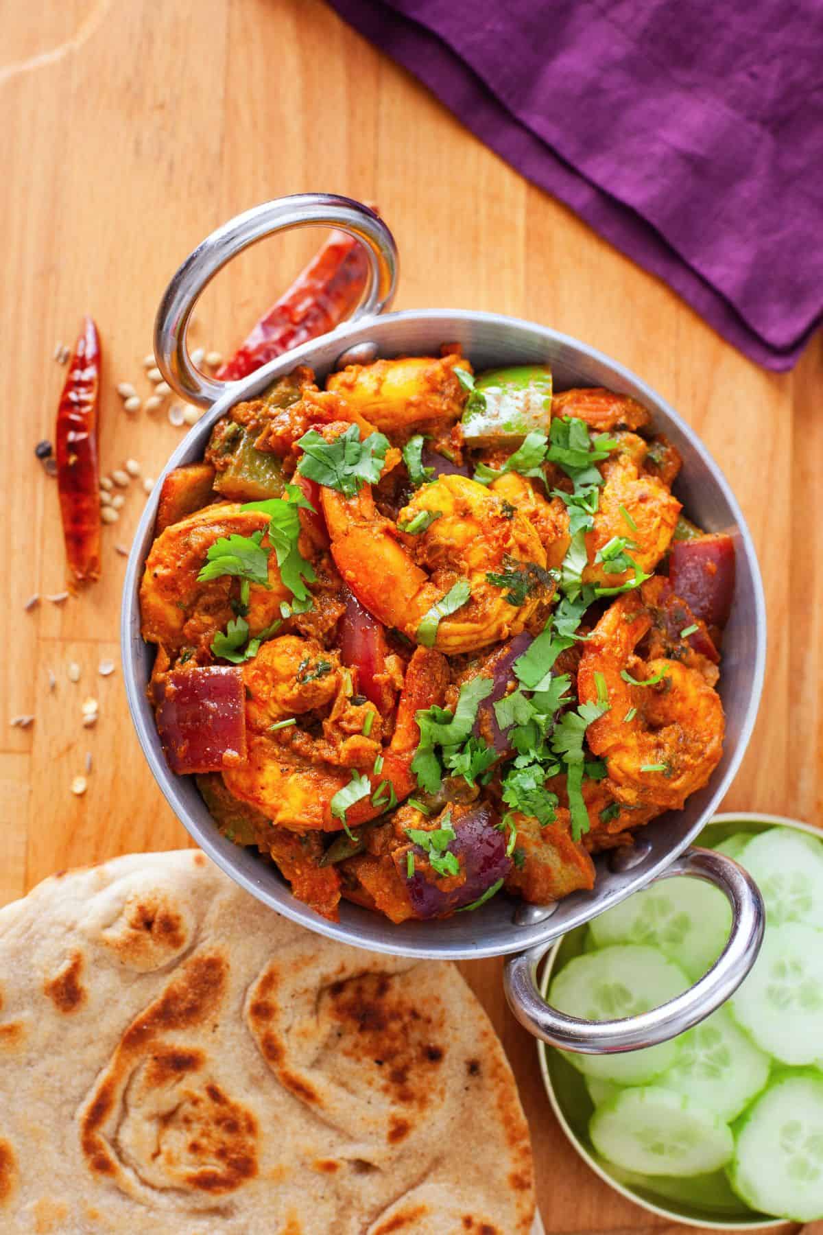 Kadai prawn served with tandoori rotis and cucumber slices. 