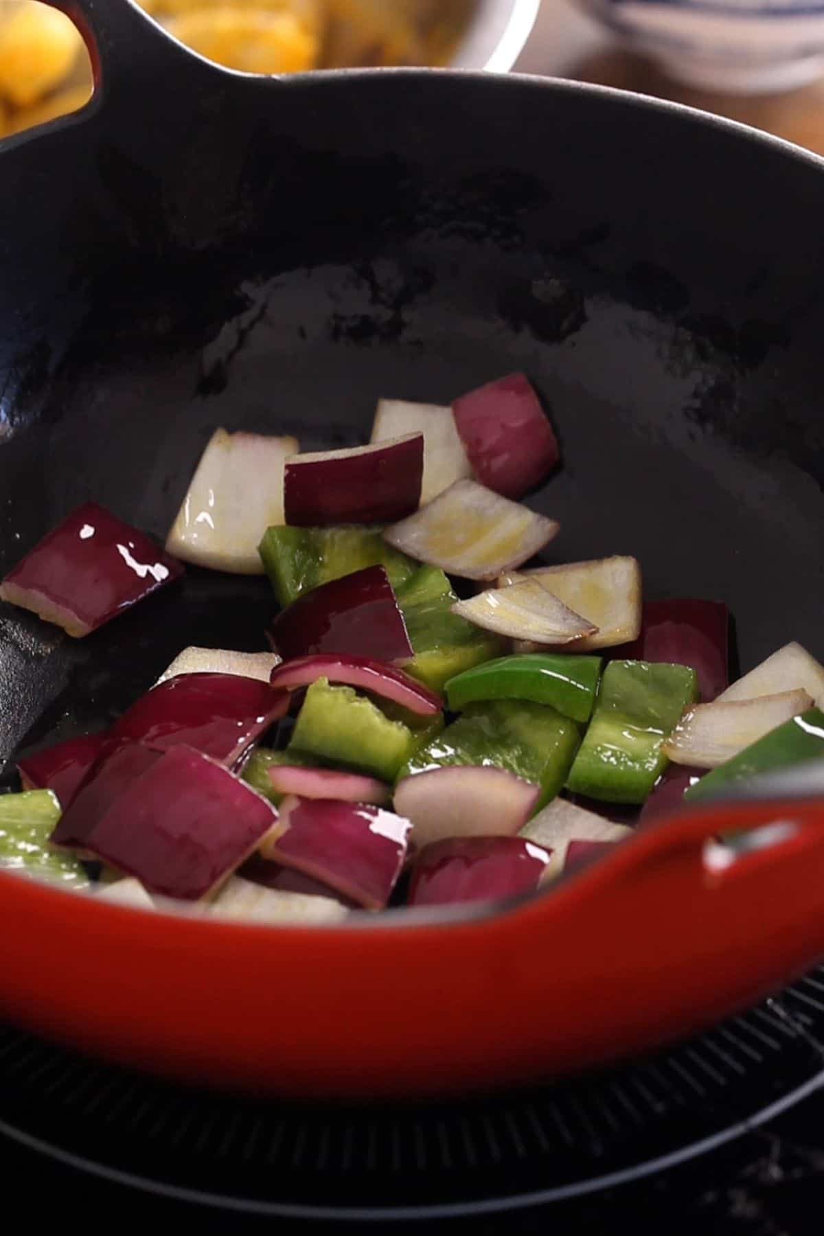 Bell pepper and onions are stir fried until a bit charred.