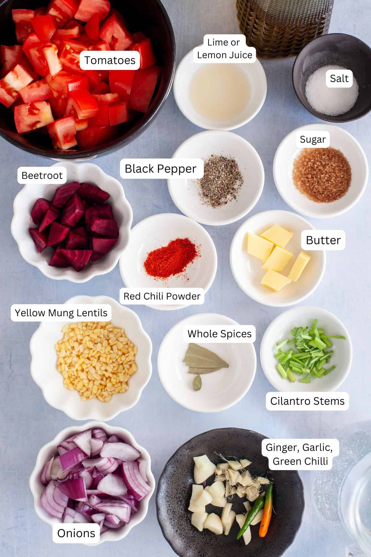 Ingredients needed for making tomato soup on a light bluw background. 