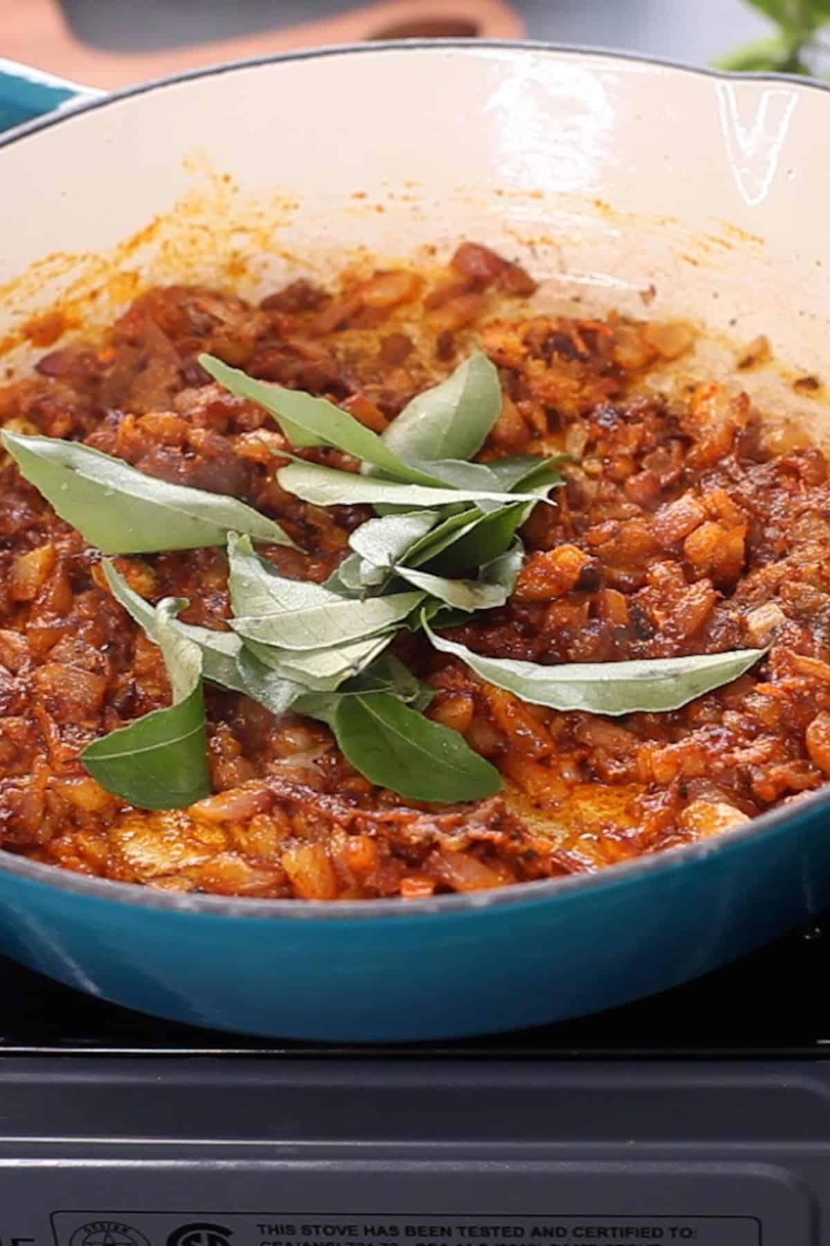 Fresh curry leaves are added to the pepper masala.