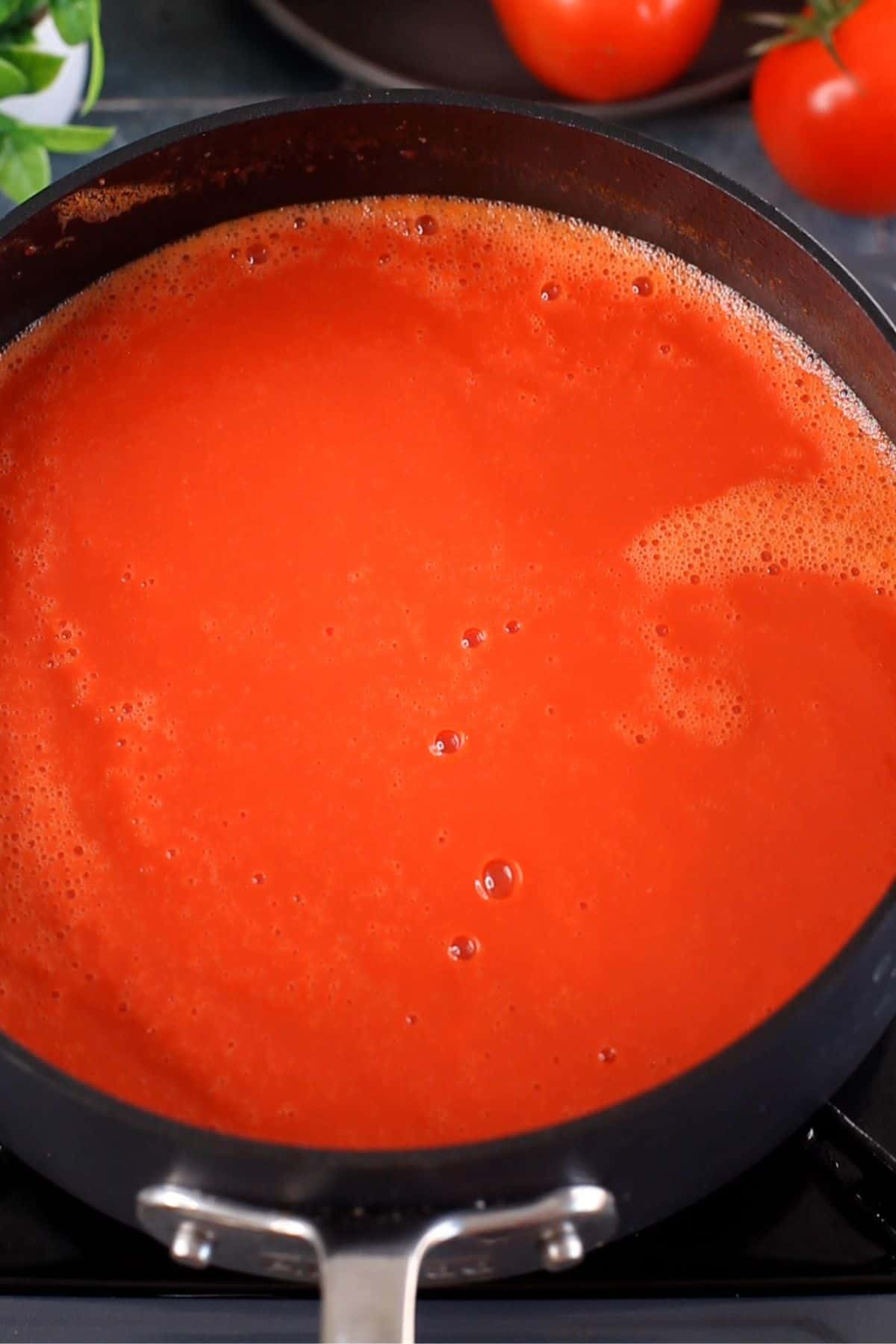 Blended soup is added back to the cooking pot.