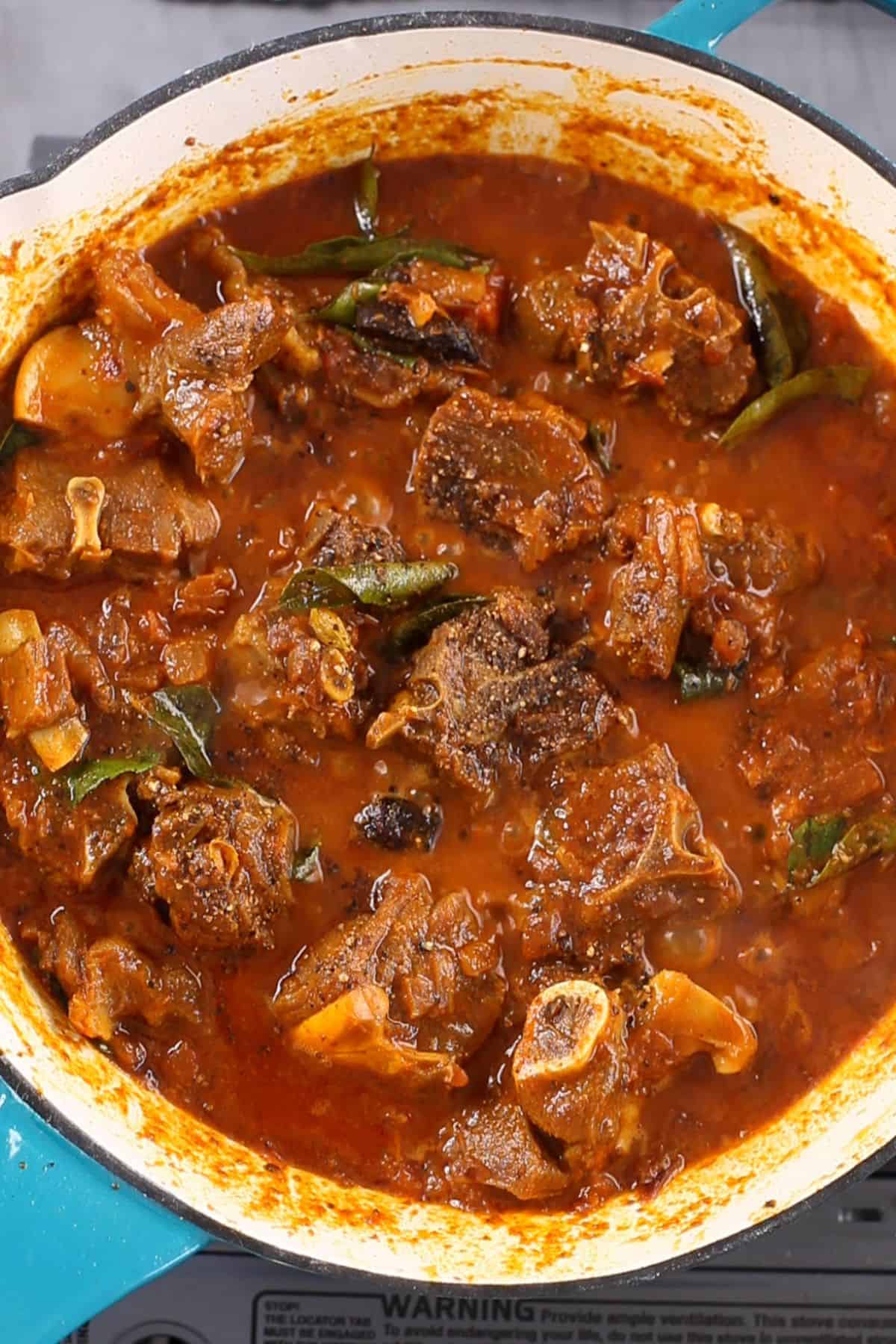 Mutton pepper fry is finished with coarsely ground black pepper.