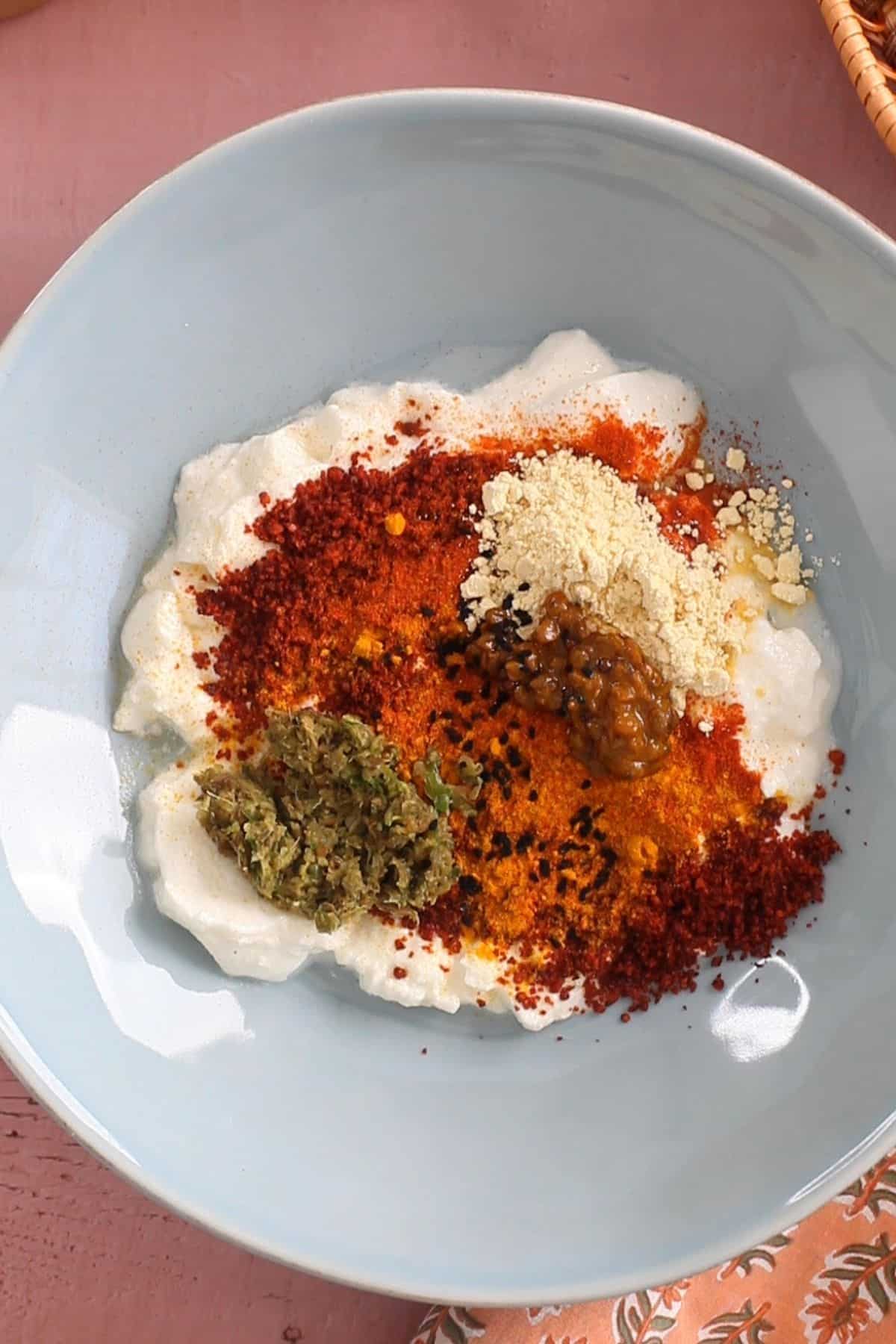 Making achari masala marinade.