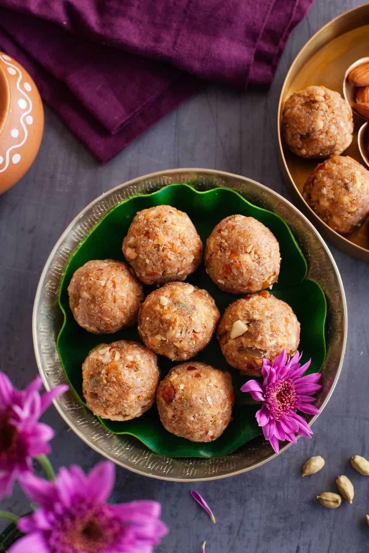Overhead view of coconut ladoo in a gold plate.