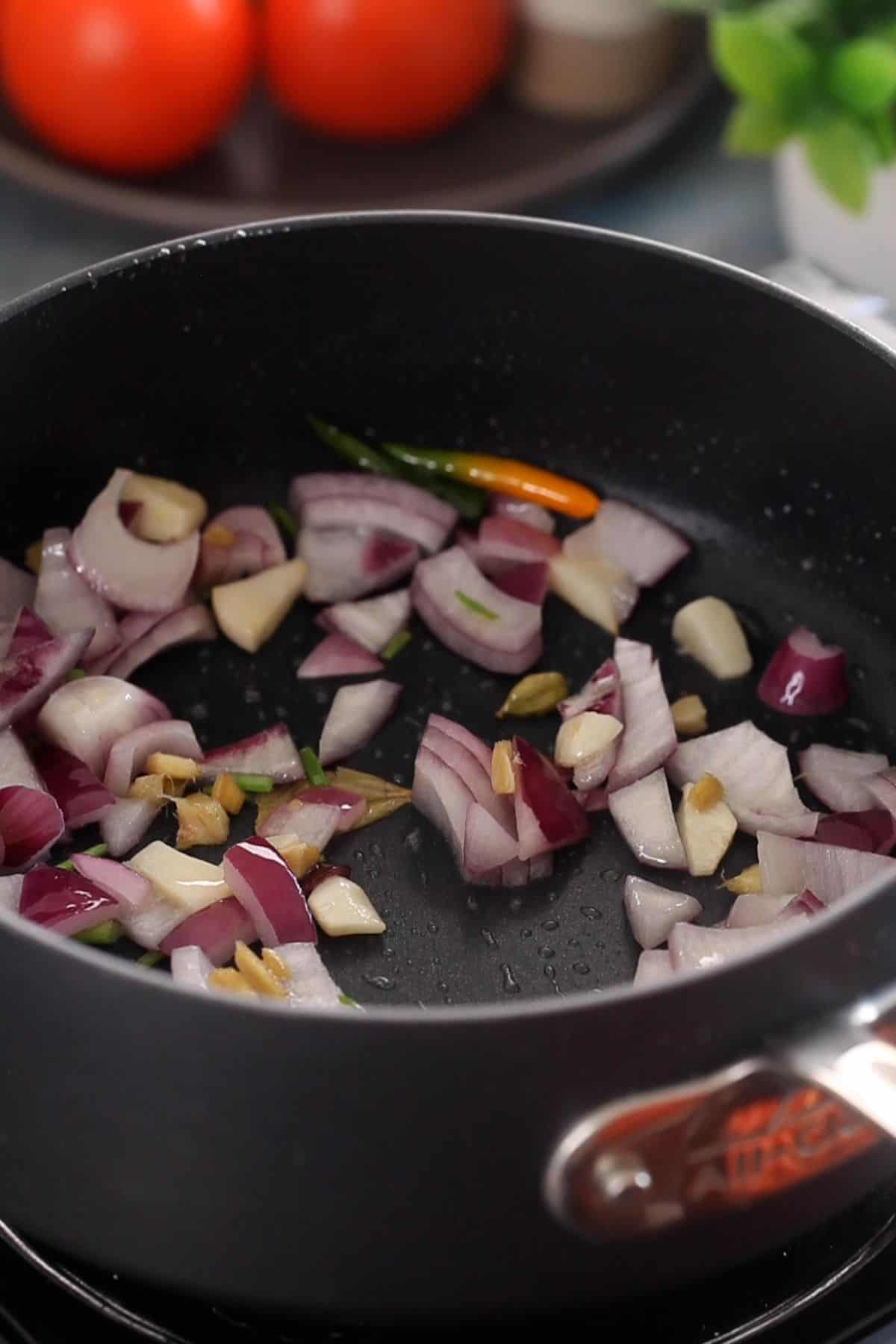 Onion is added to the cooking pot.
