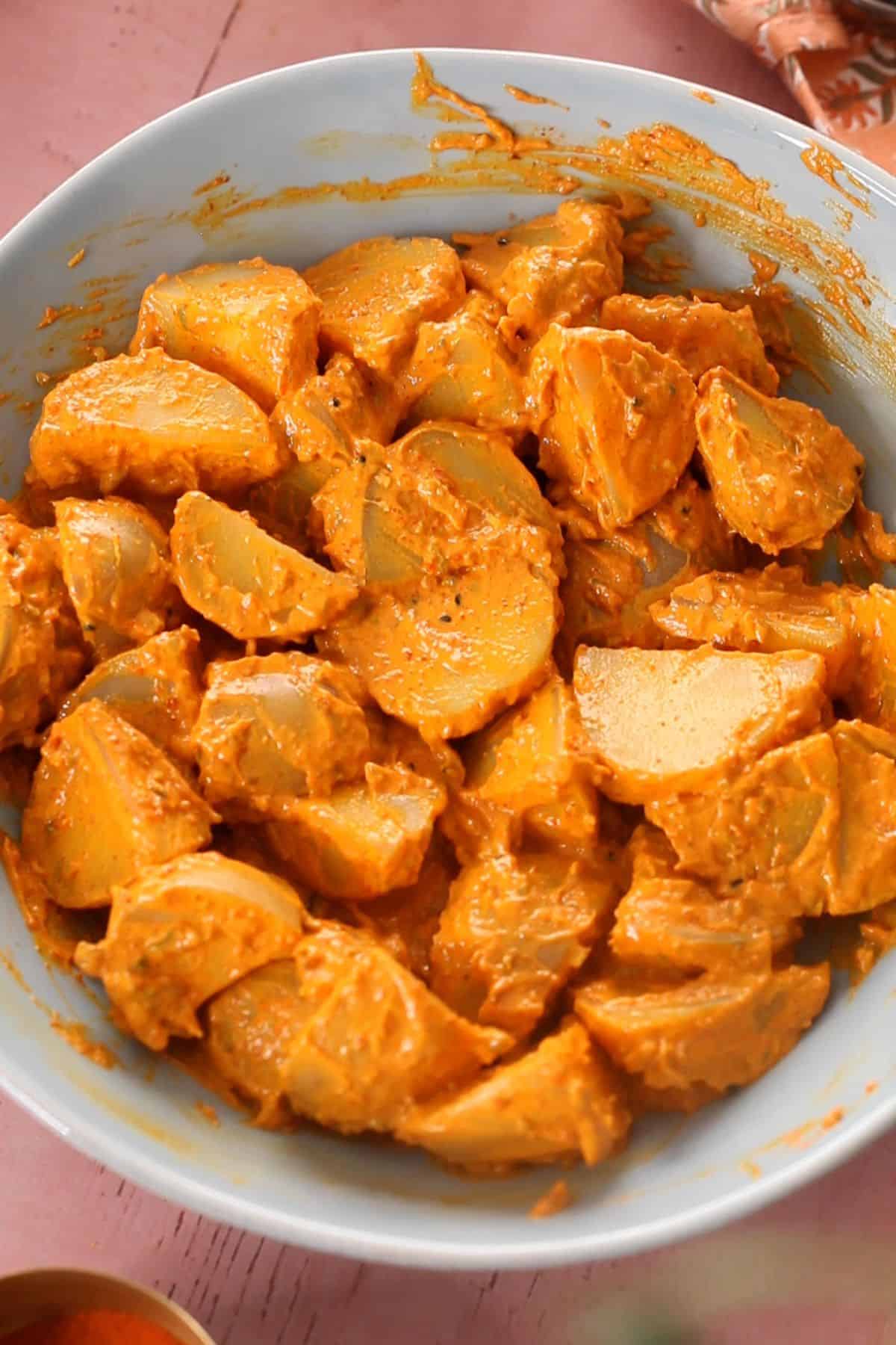 Potatoes are coated in the achari marinade and then set to rest.