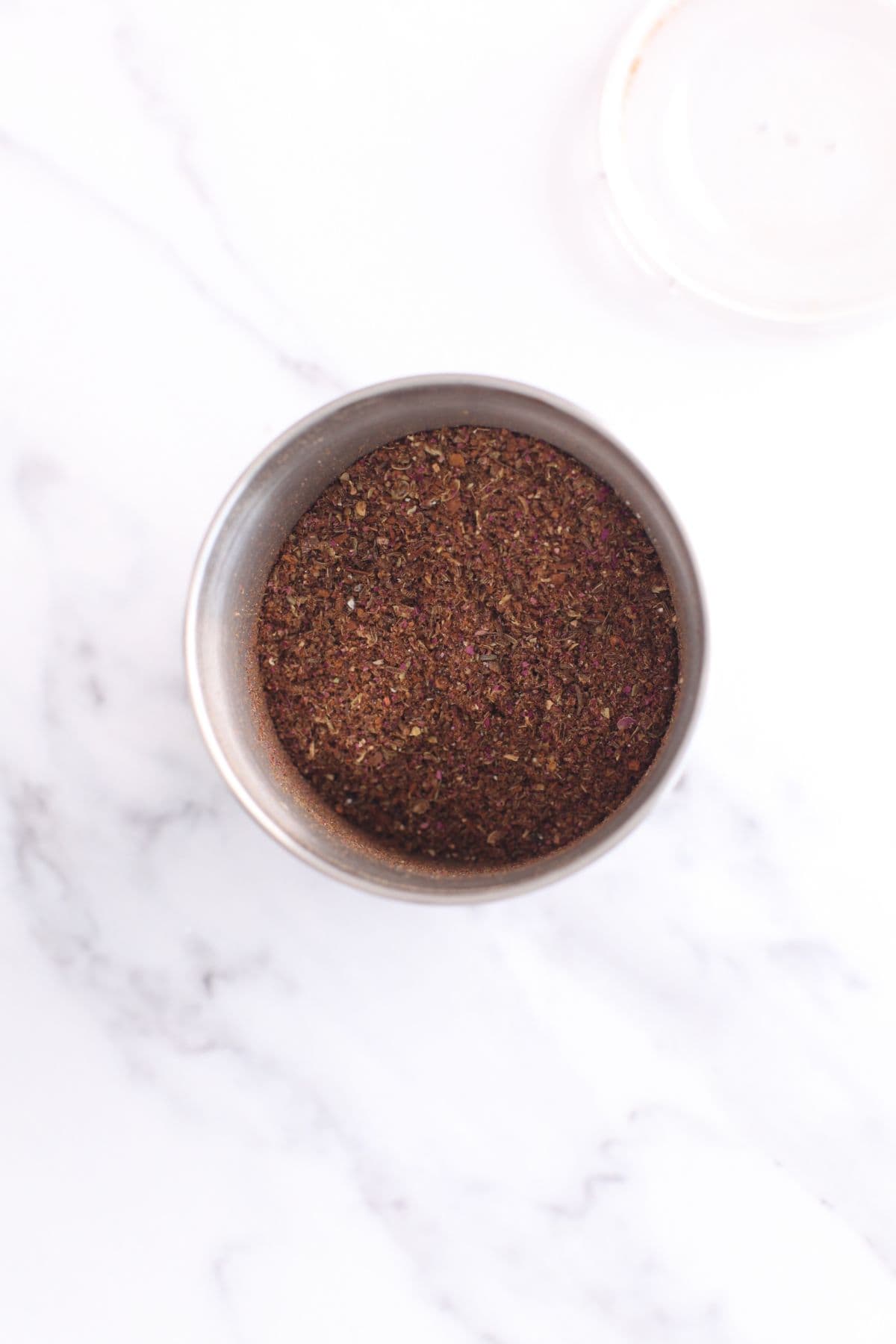 Homemade biryani masala is ground in a small blender jar.