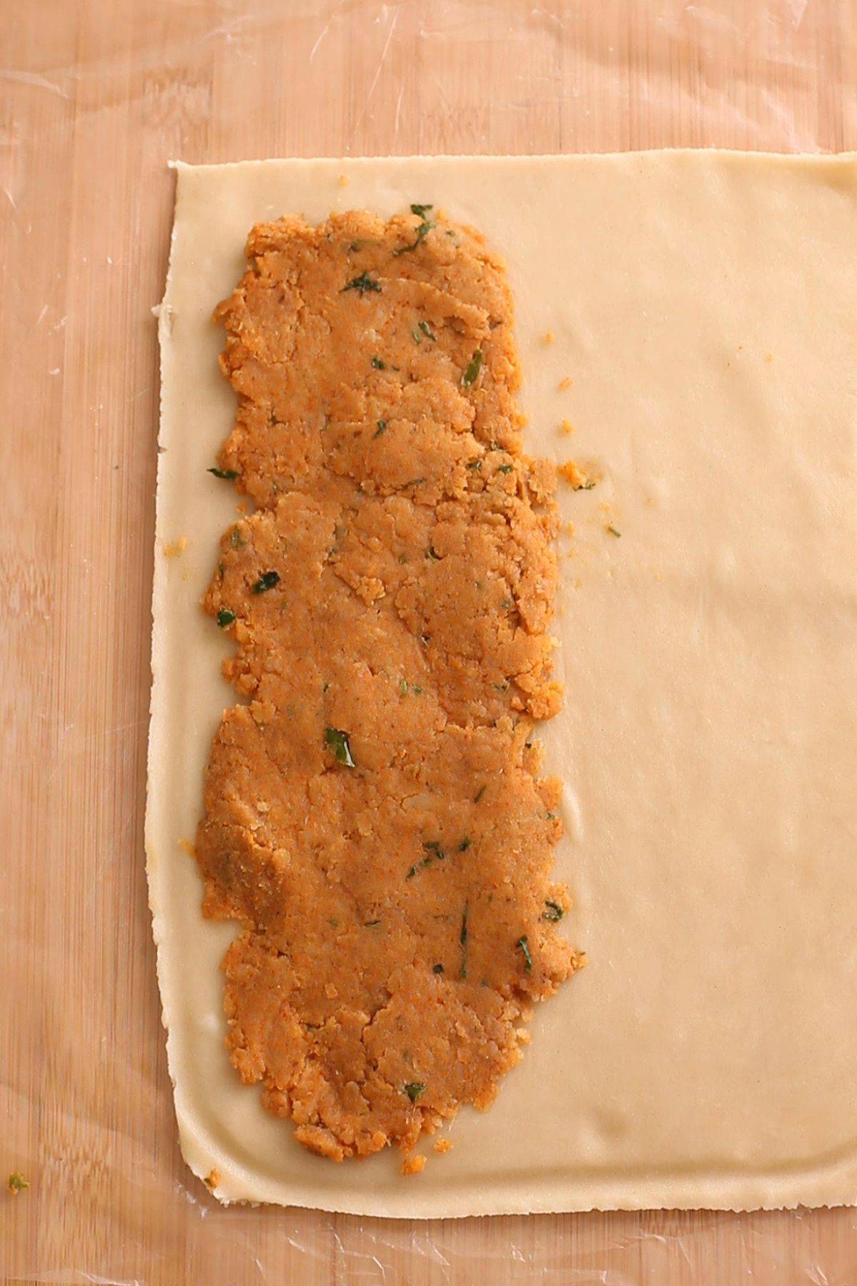 Potato filling is spread on one half of pie crust.