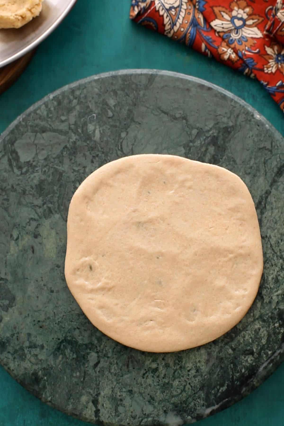 dough is rolled into a circular kachori.