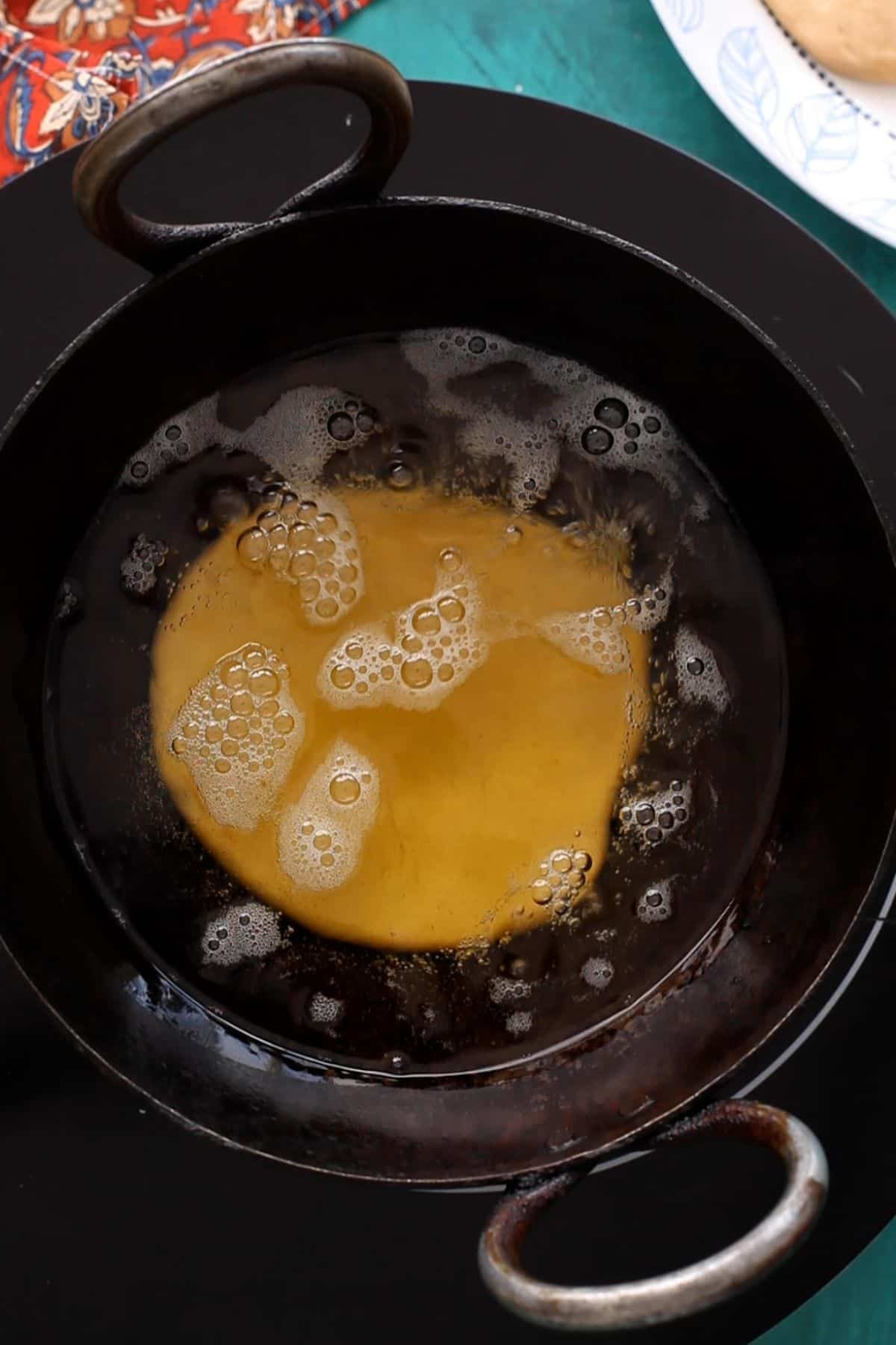 Kachoris are added to hot oil. 