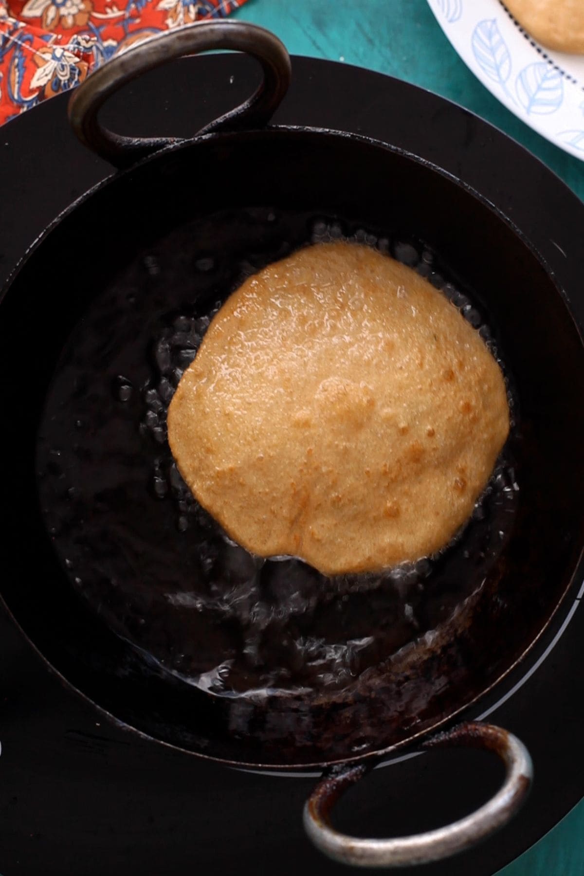 Kachori is puffing up in hot oil.