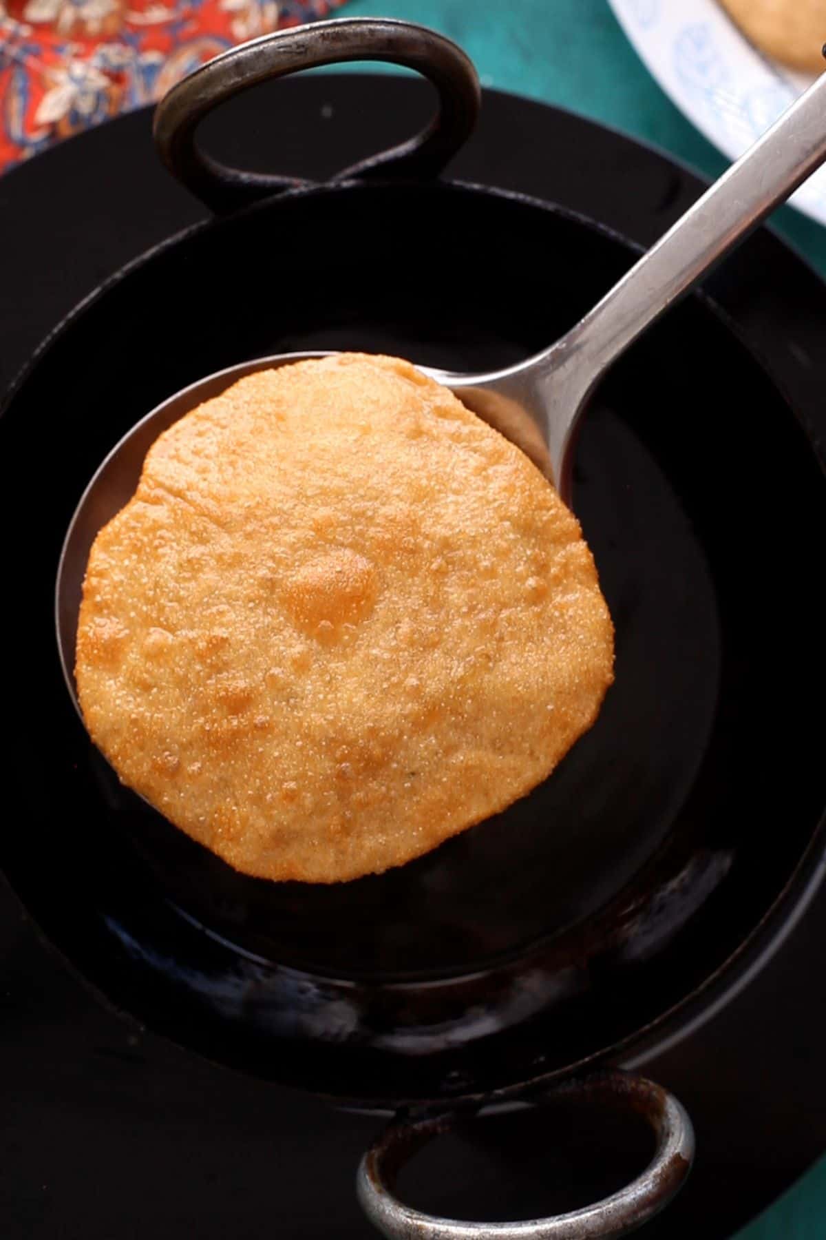 Deep fried urad dal kachori is golden brown and ready.