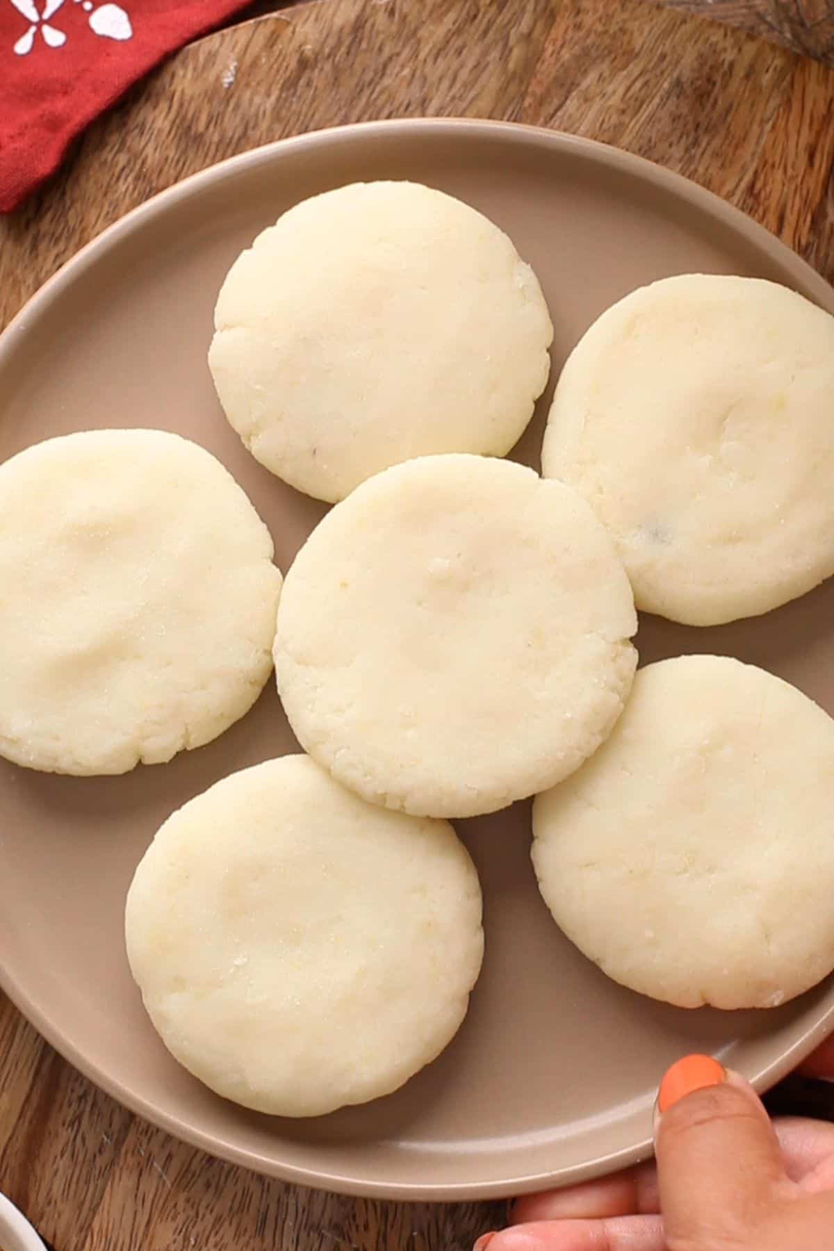 Shaped aloo tikki placed in a brown plate ready for frying.