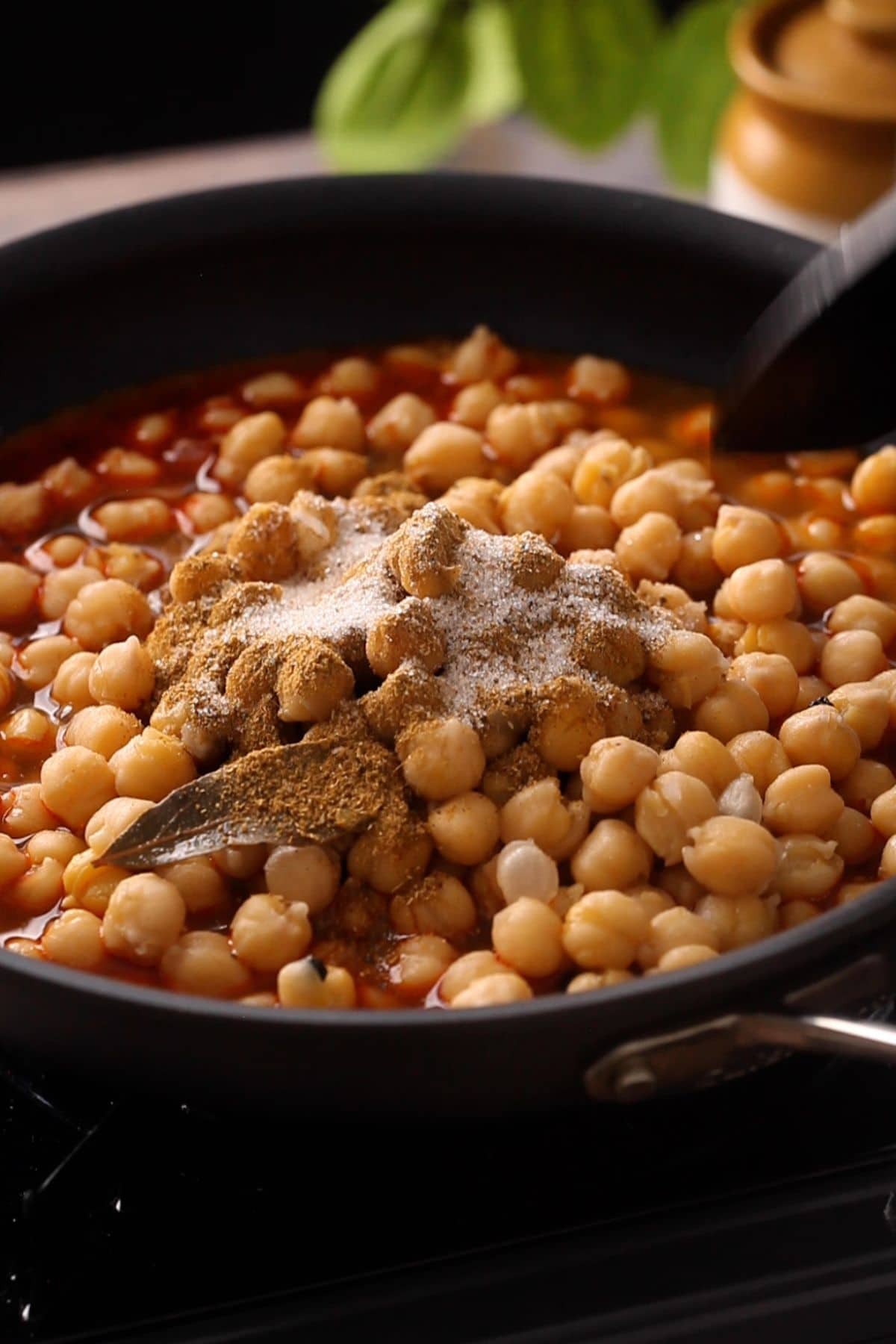 Boiled chickpeas are added next along with chana masala powder and salt.