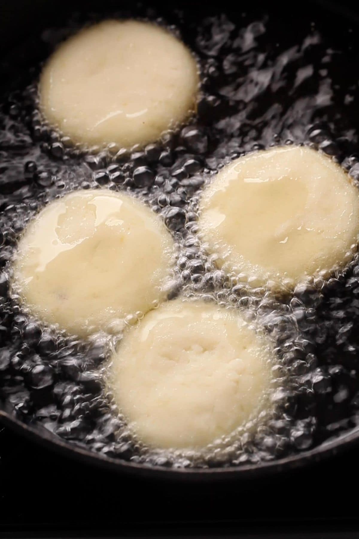 Aloo tikki are shallow frying in oil.