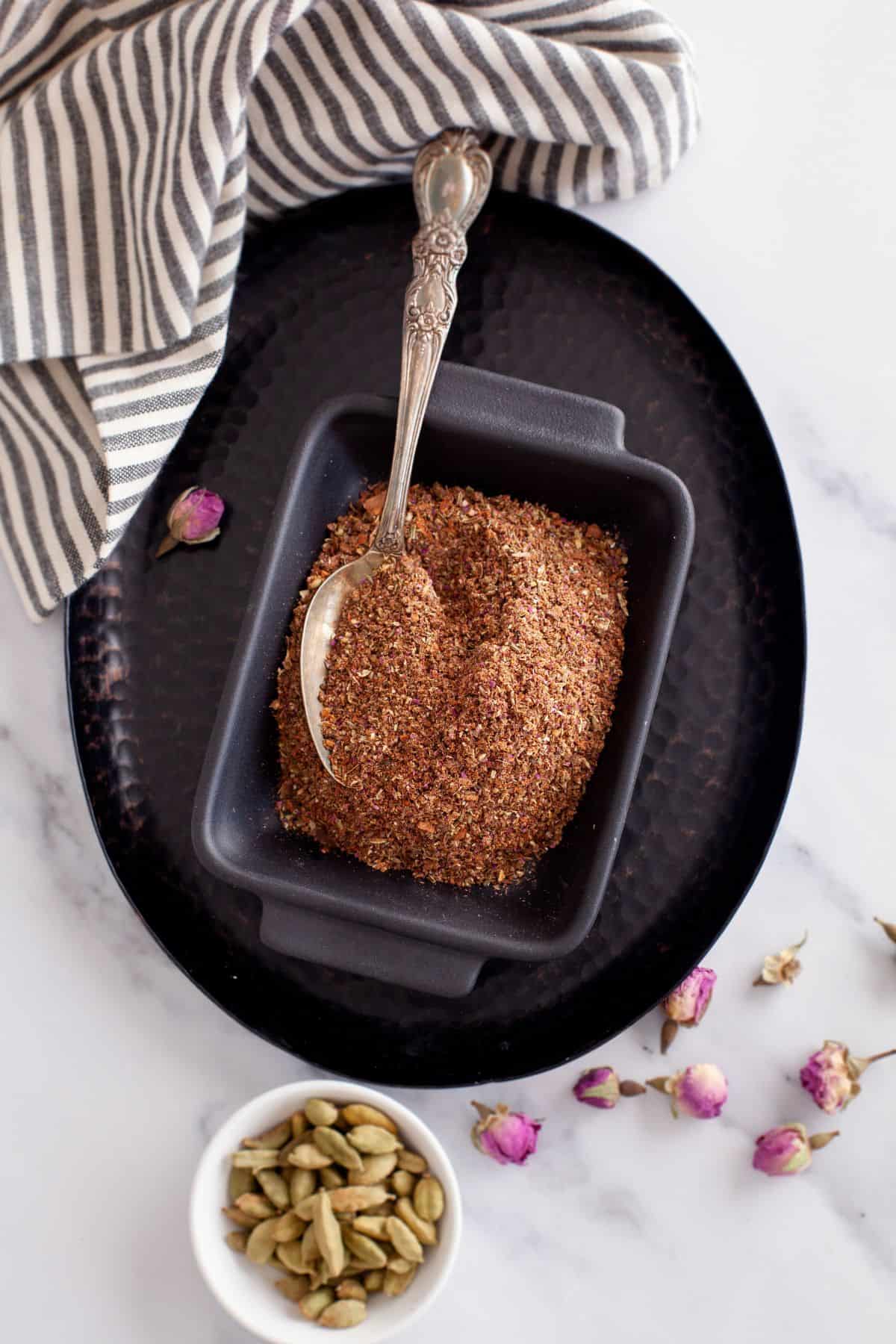 Biryani powder placed in a rectangular black dish.