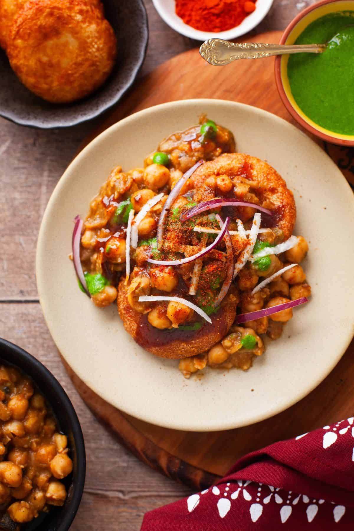 Overhead Image of tikki chole chaat placed on a wooden background.