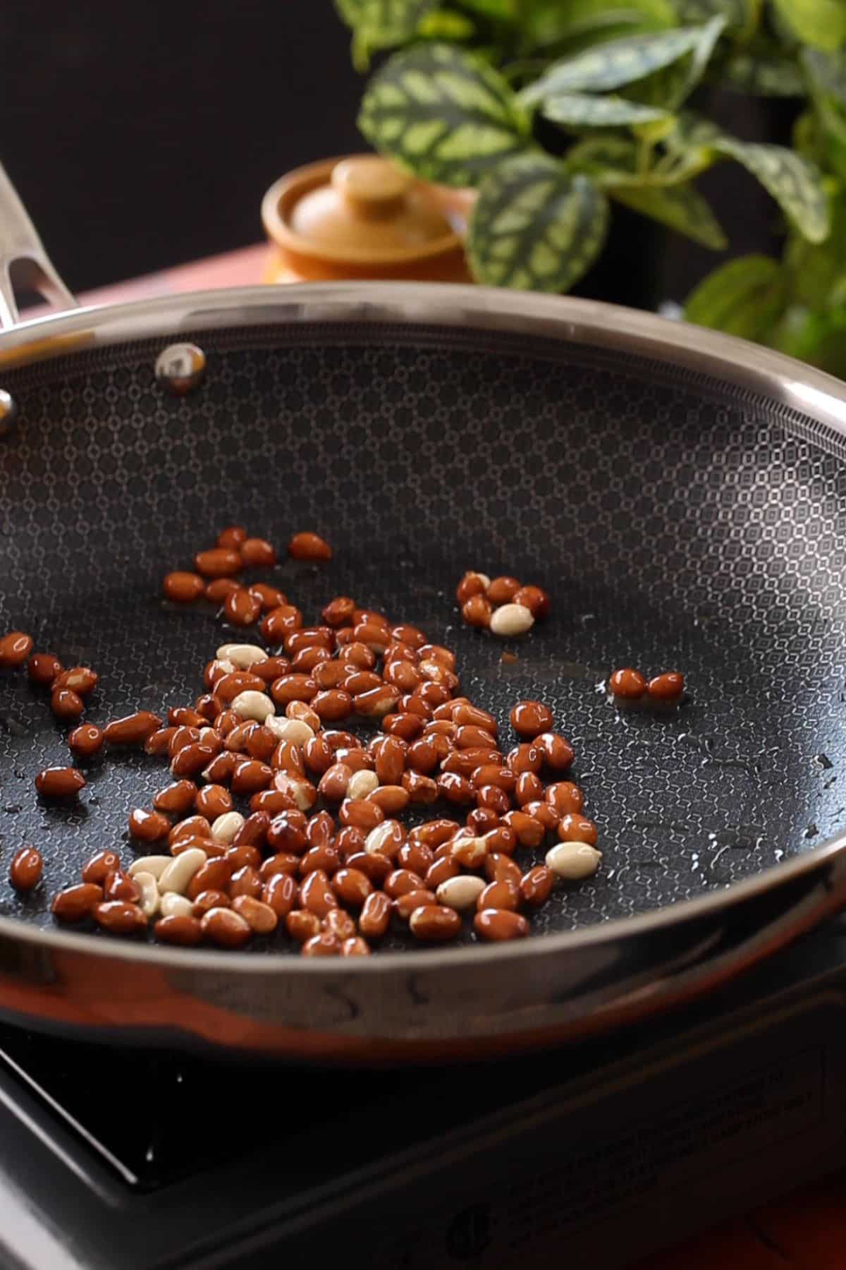 Roasted Peanuts in a black skillet.