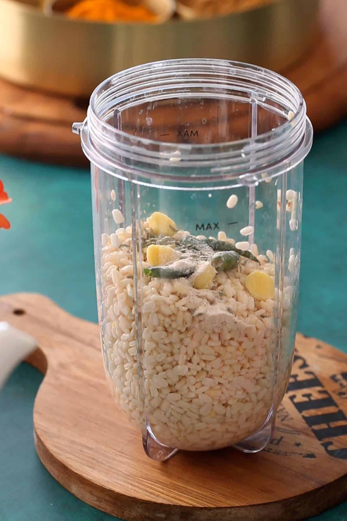 Soaked urad lentils, spices , ginger and green chili in a blender jar.