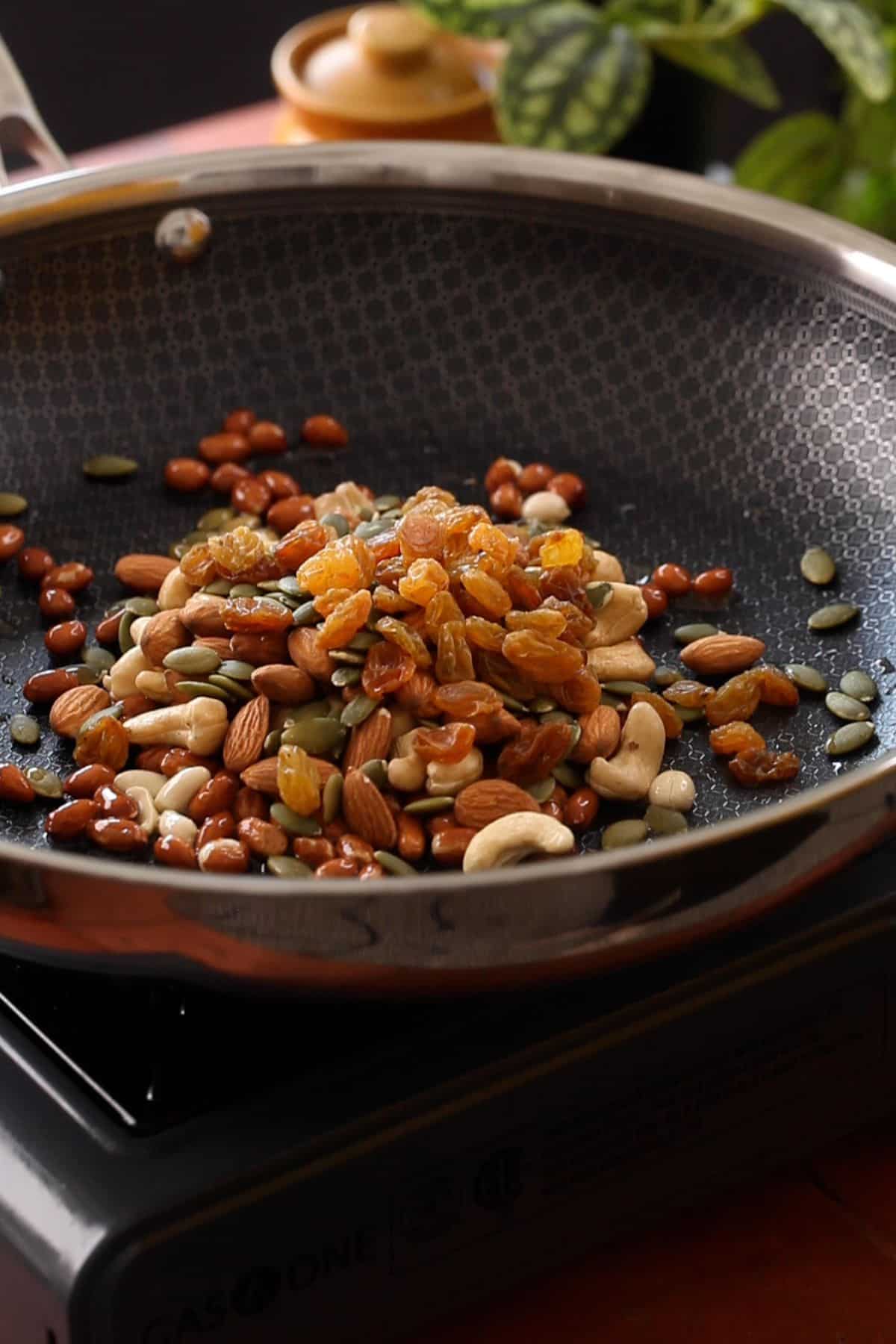 Nuts, raisins and pumpkin seeds are added to roasted peanuts.