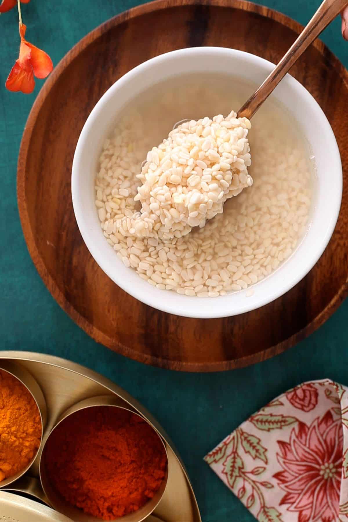 soaked urad dal in a white bowl.