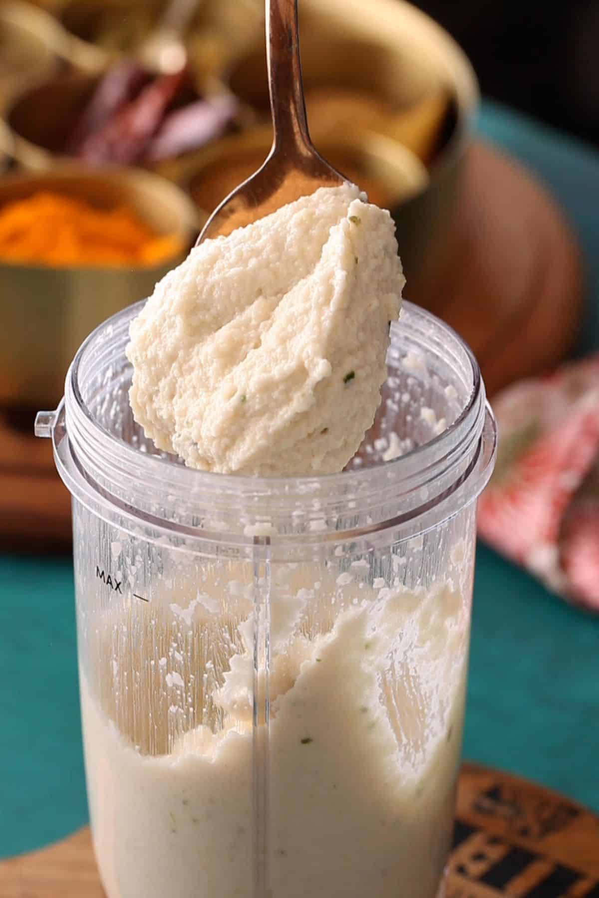 Ground lentils on a copper spoon.