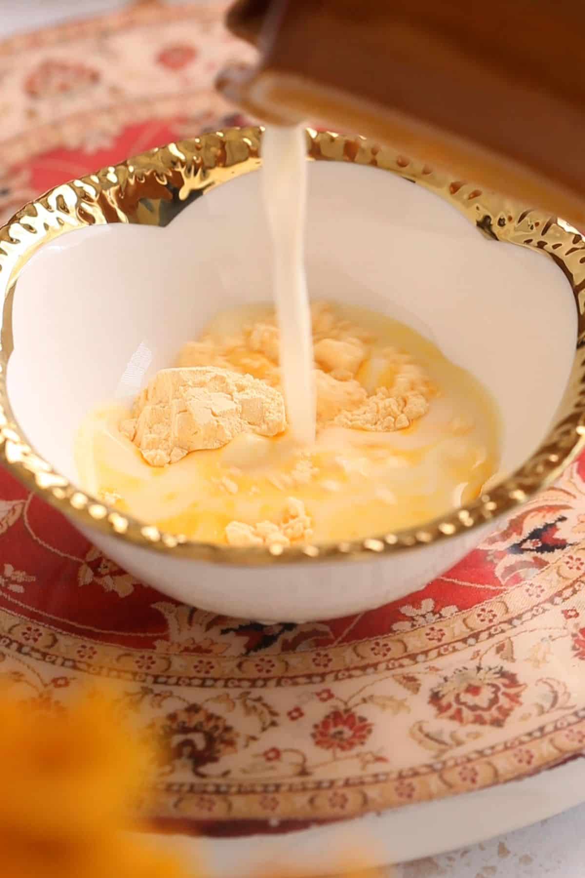 Milk is poured over custard powder.