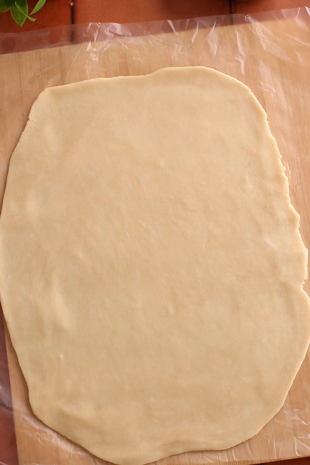 Rolled pie crust on a wooden board.