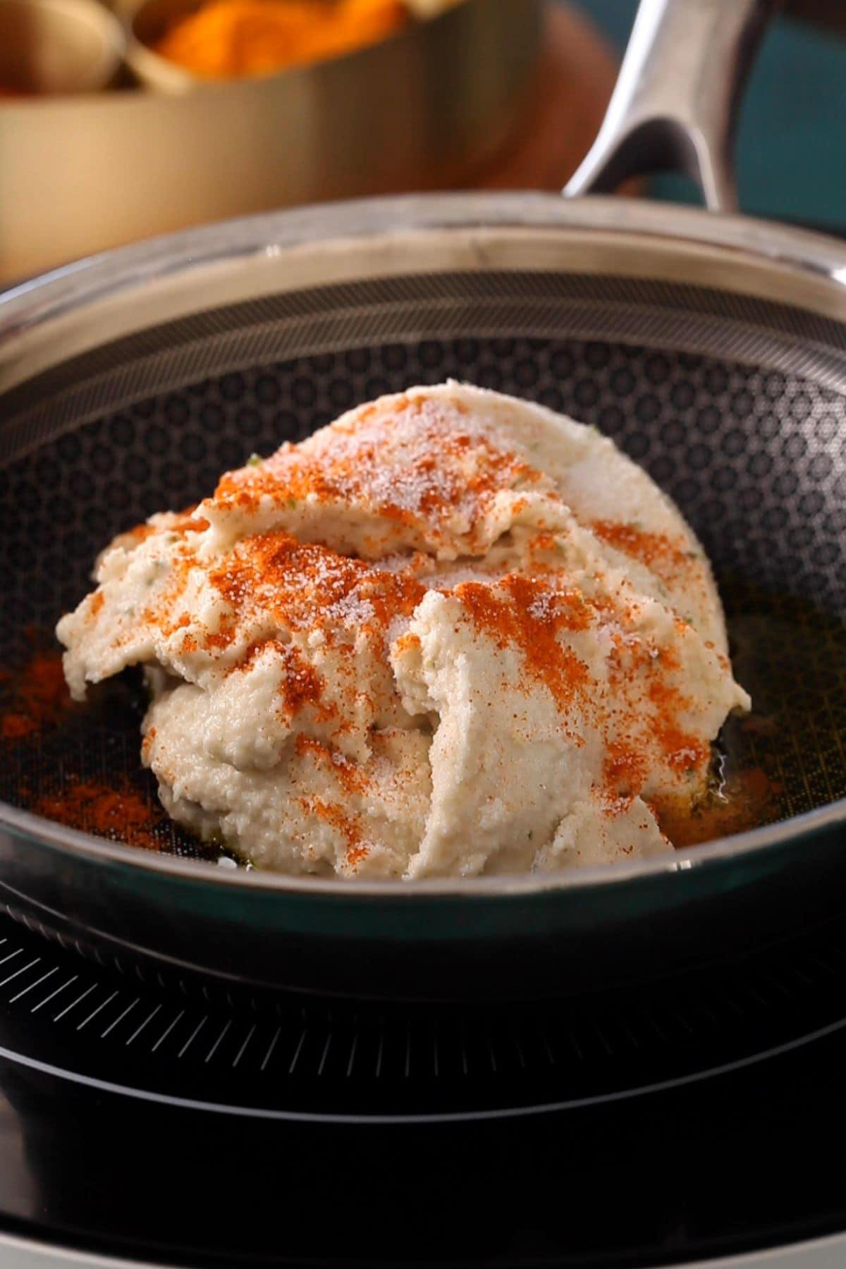 Ground lentils are sprinkled with salt and spices.