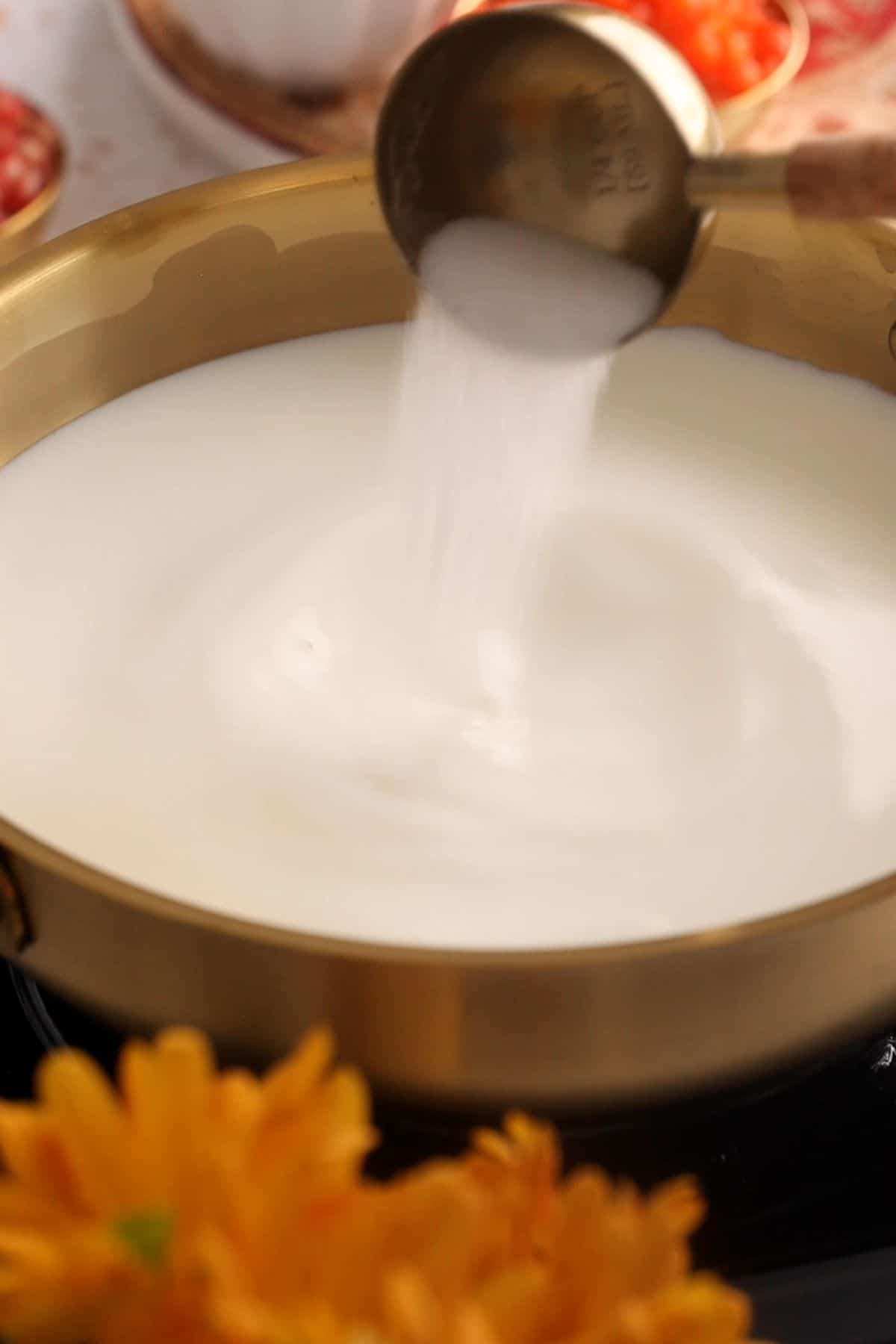 Sugar is added to milk.