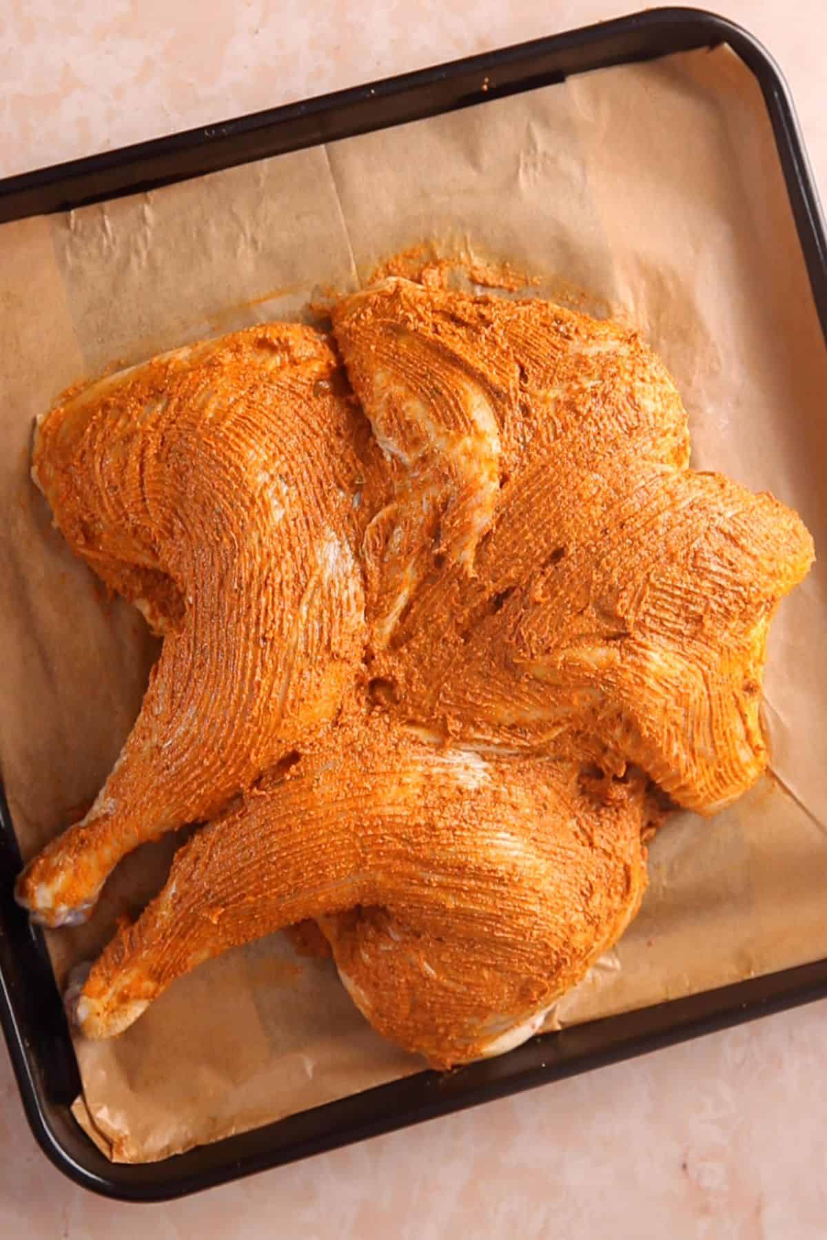 Compound butter is rubbed all over the chicken skin.