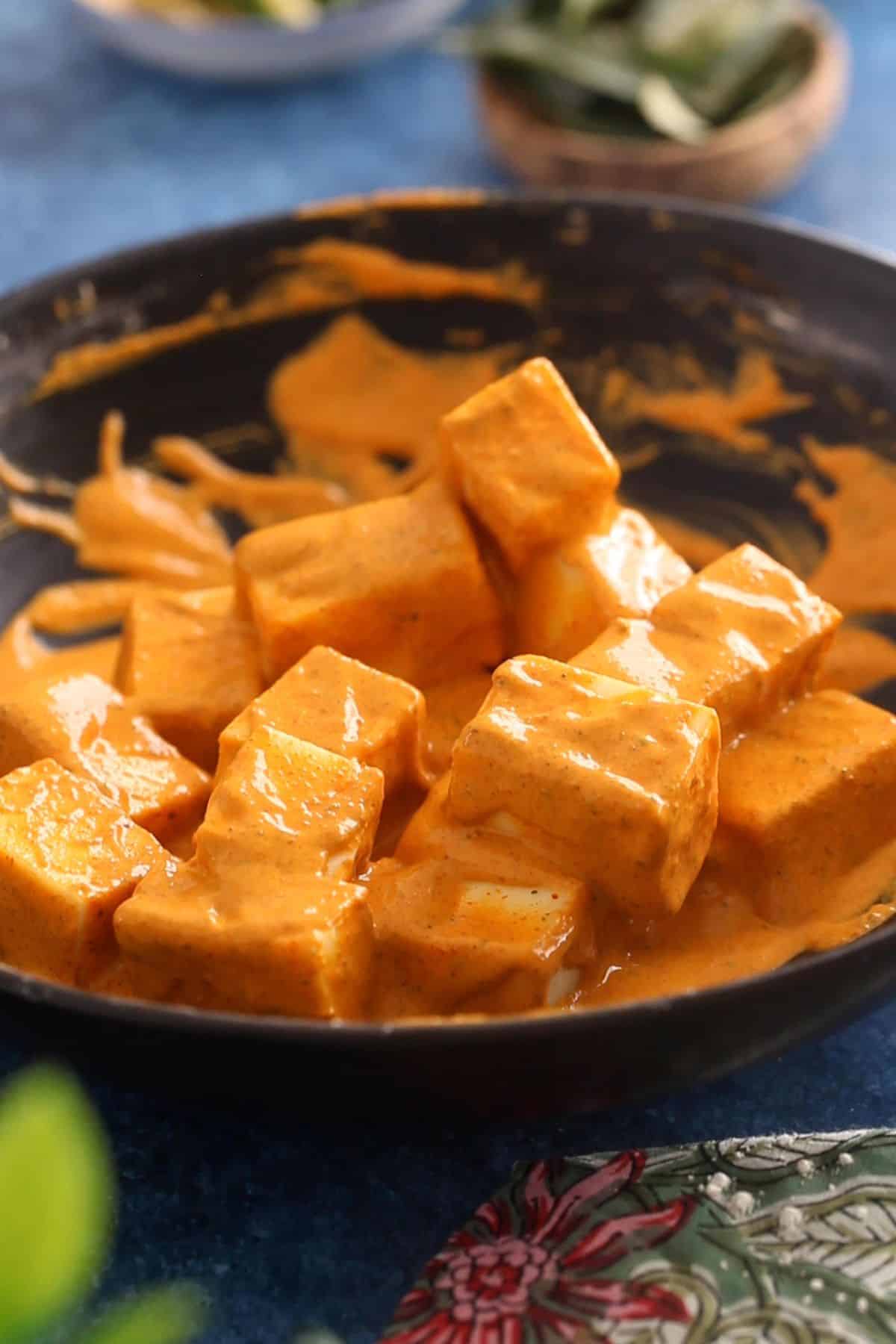 Paneer pieces are coated in the thick batter.